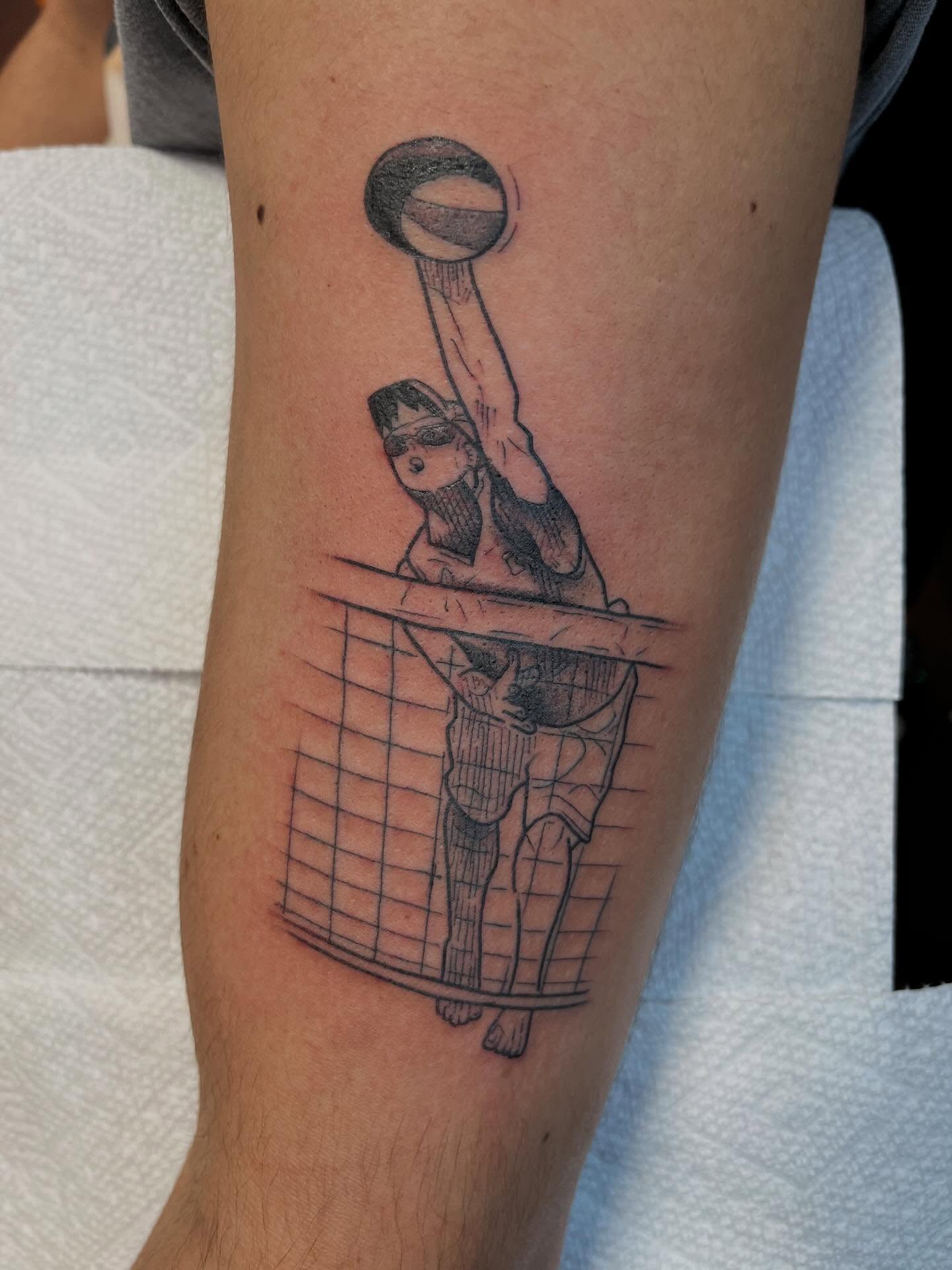 Basketball player black and grey tattoo on the forearm by Evan Voelker