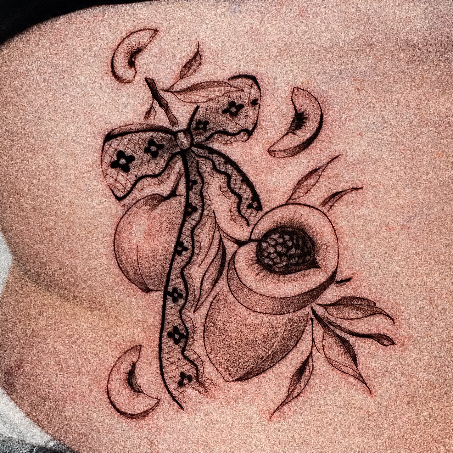 Butterfly and flower black and grey tattoo on the torso by Kalin, Seattle, Washington