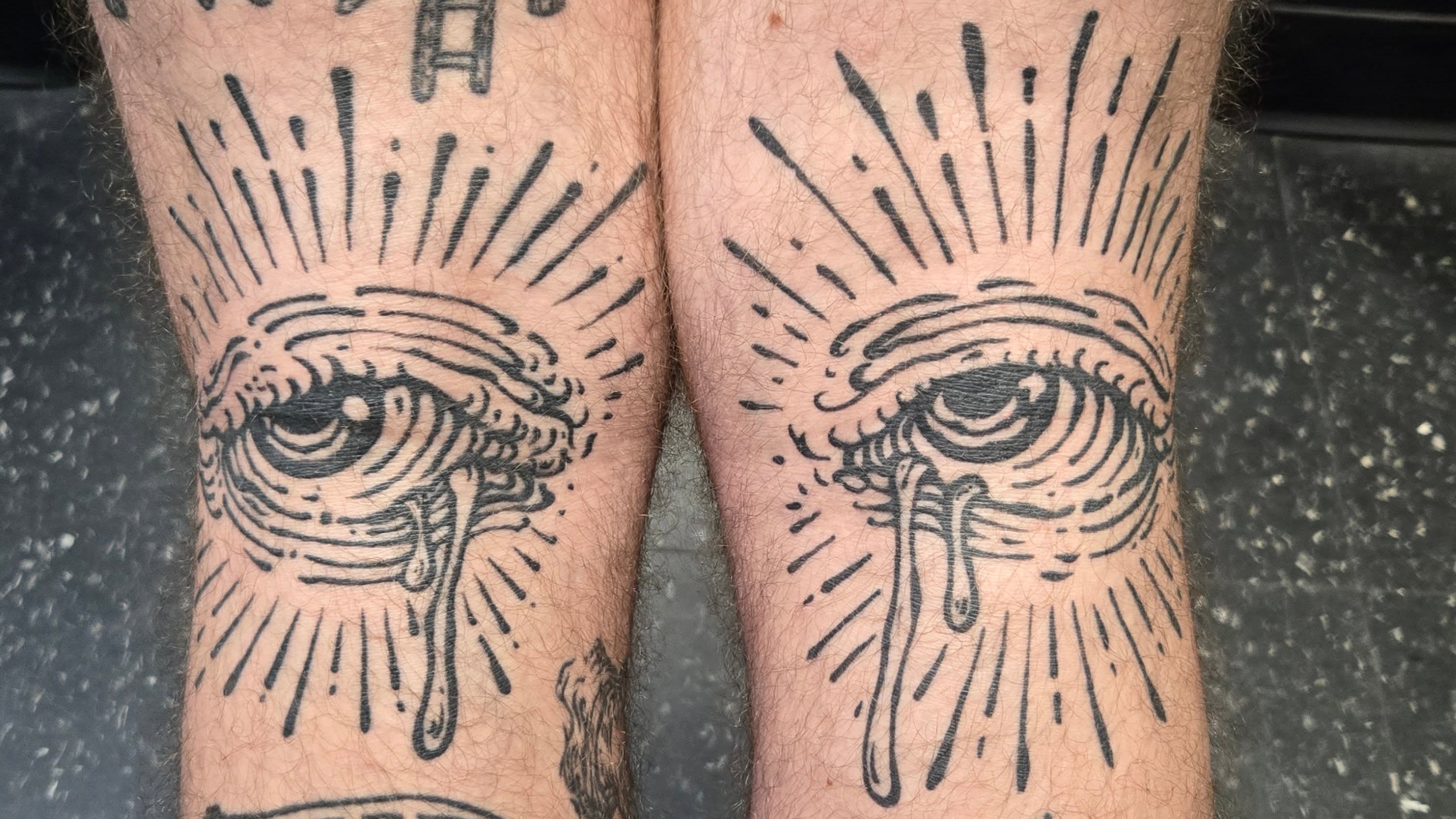 Tearful eye black and grey tattoo on the forearm by Angel O'Connor Tattoos