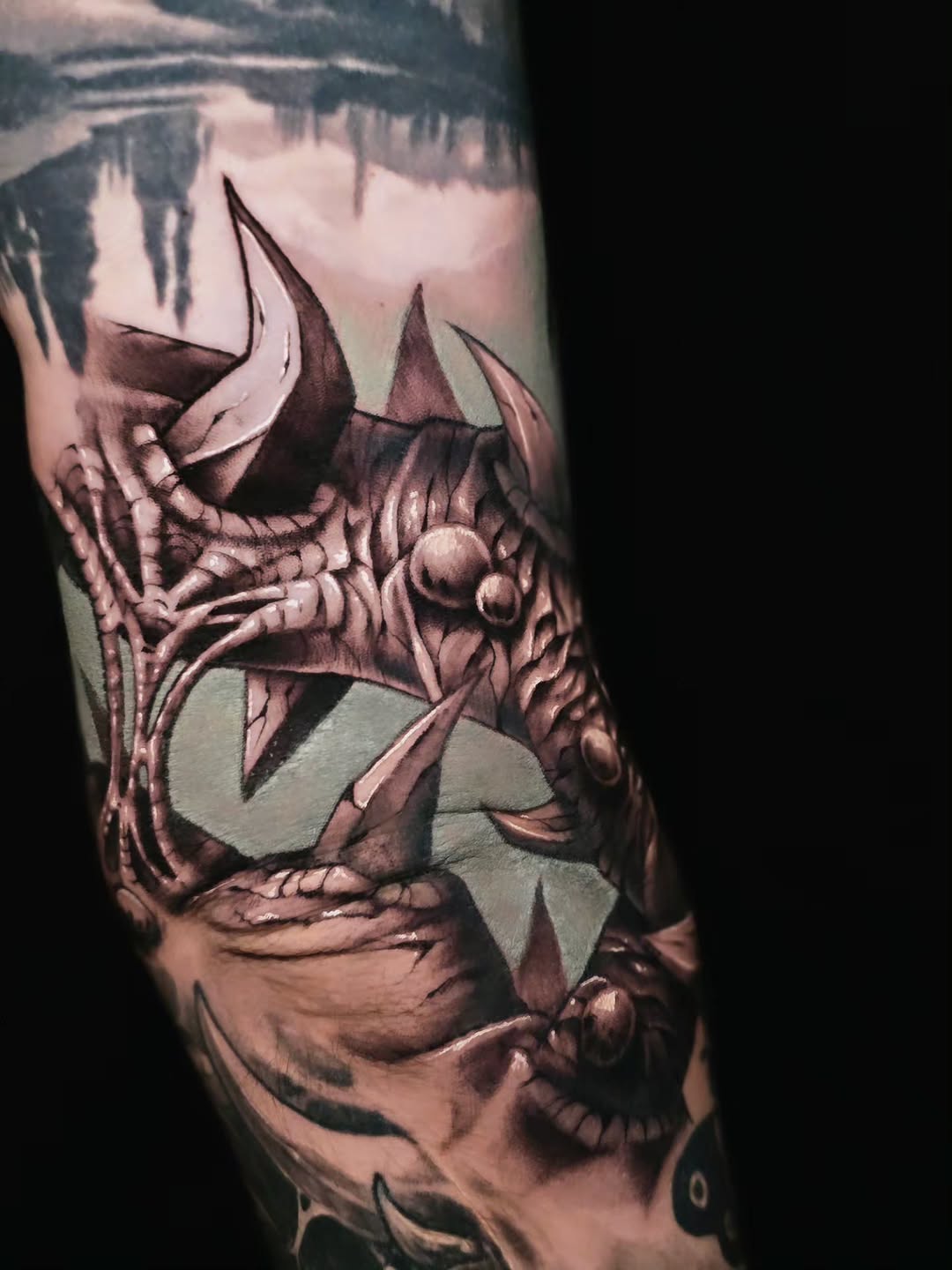 Biomechanical dragon head realism tattoo on the forearm by Jake Barney