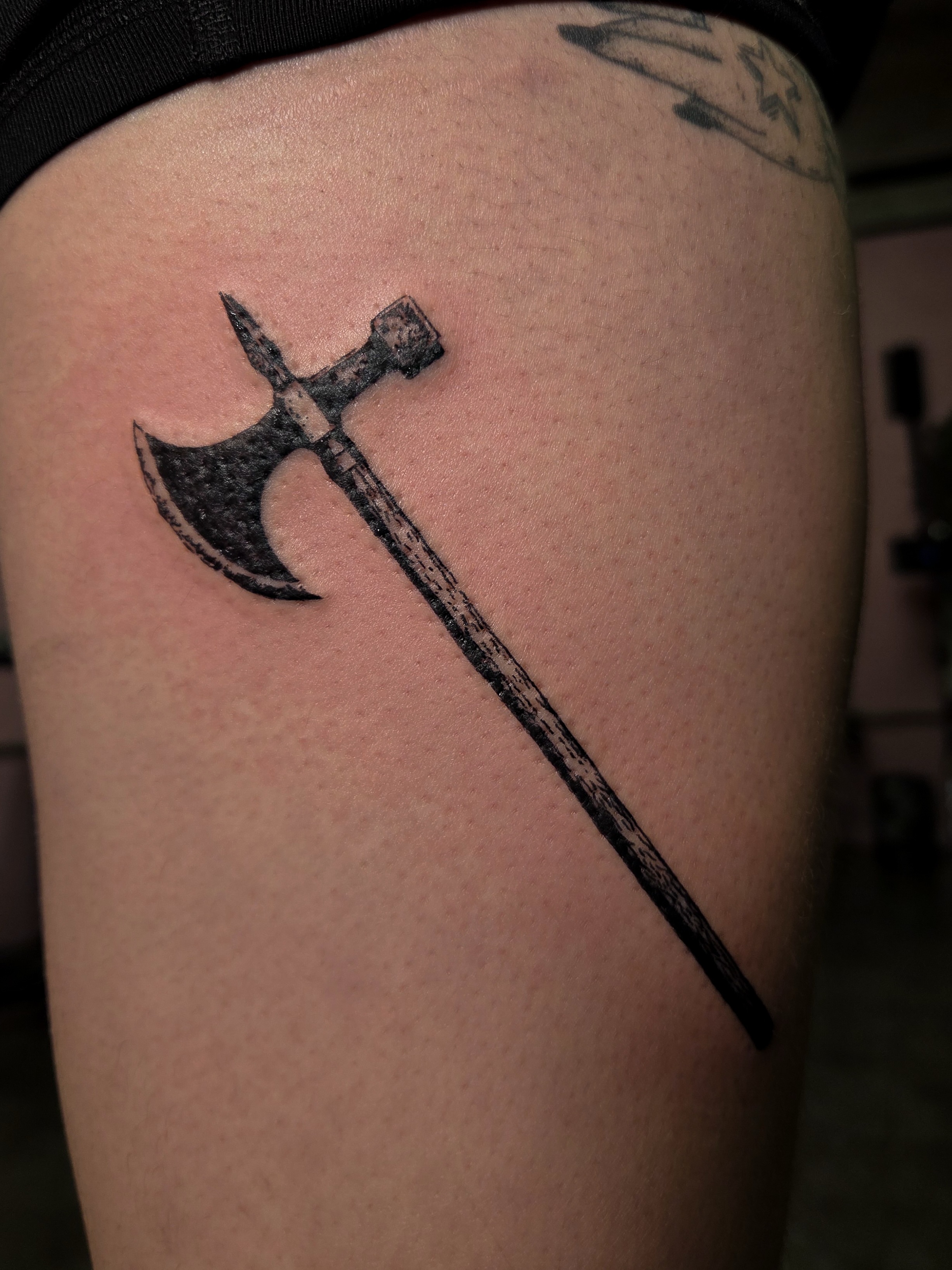 Battle axe black and grey tattoo on the thigh by Tattoo Artist X Kamm, Salt Lake City, Utah