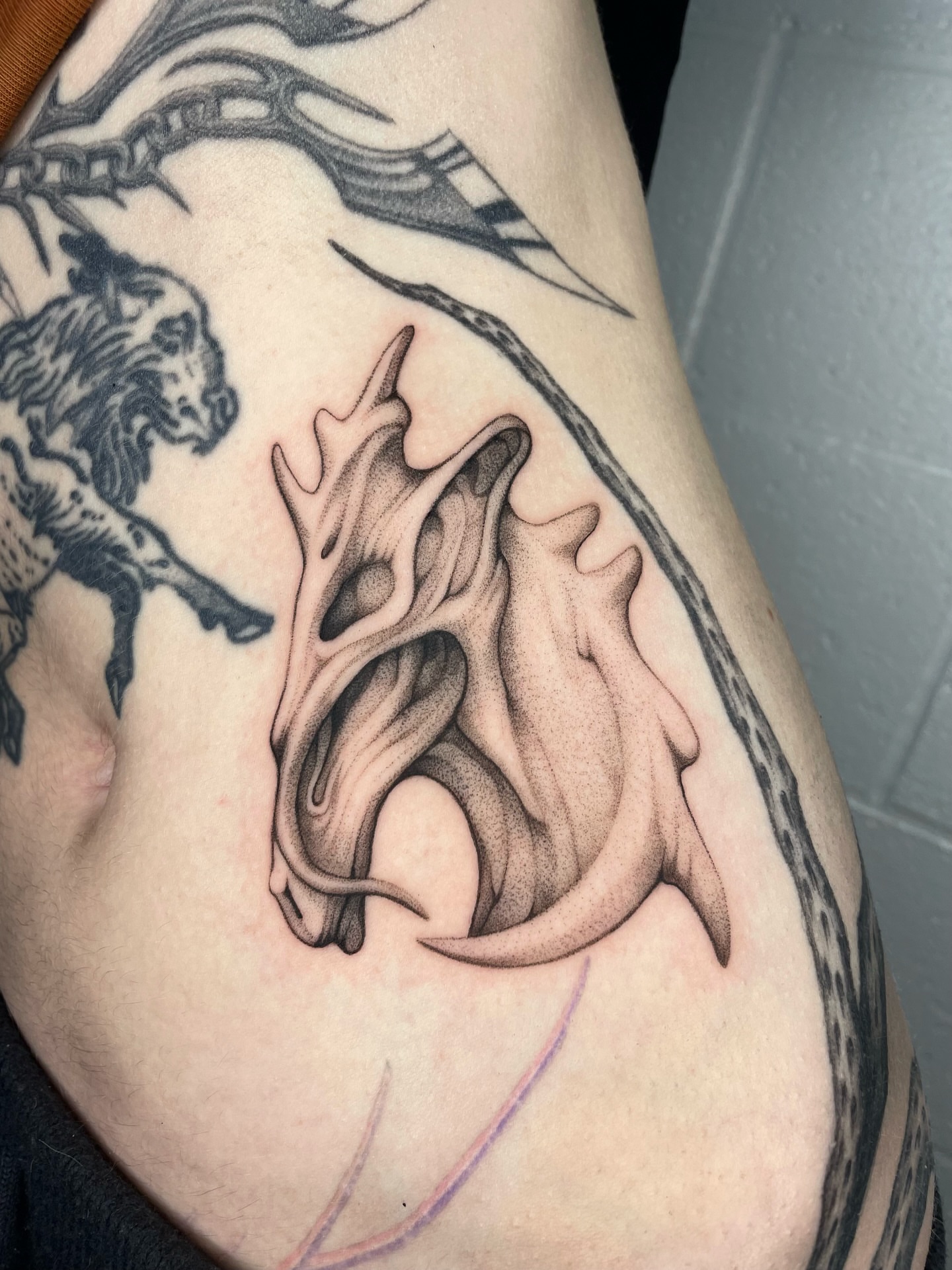 Antlers and flames black and grey tattoo on the forearm by 𝕮𝖆𝖗𝖔𝖑𝖎𝖓𝖊 𝕽𝖆𝖊 𝕽𝖔𝖇𝖎𝖓𝖘𝖔𝖓, Los Angeles, California