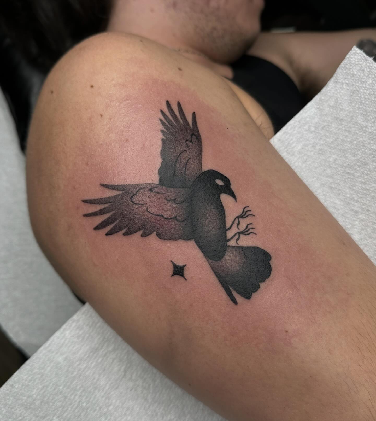 Crow black and grey tattoo on the shoulder by Aleksandra