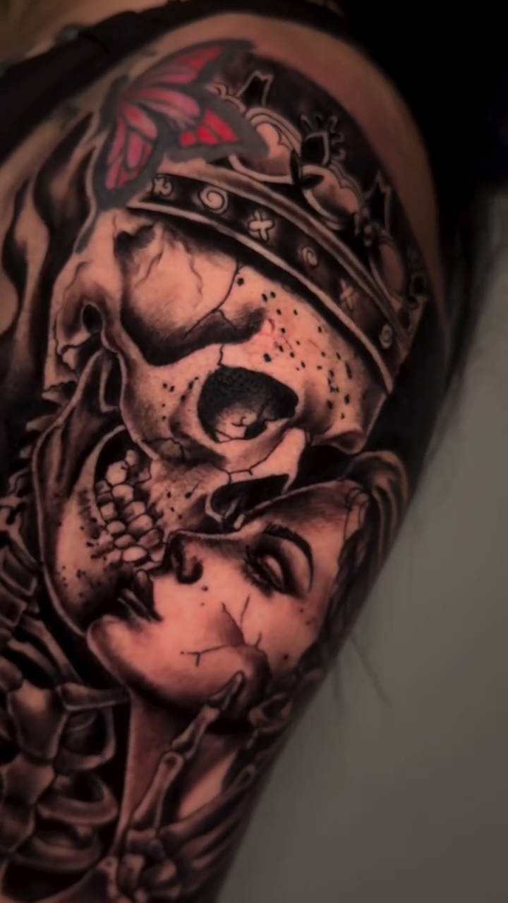Skull and woman with crown realism tattoo on the upper arm by Anghel Patricia