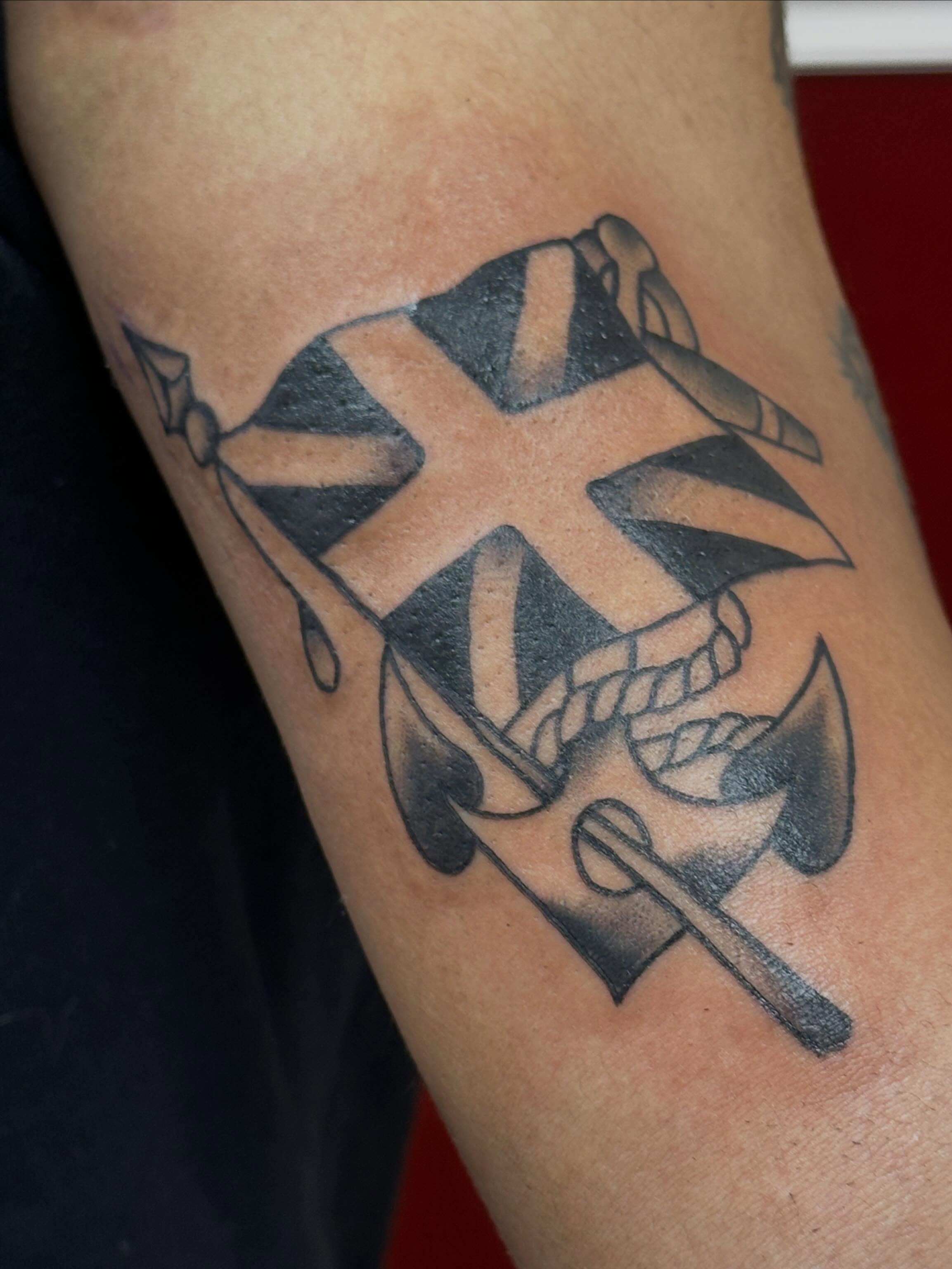 Pirate flag and anchor black and grey tattoo on the forearm by Colbylee Tattoo Norwich