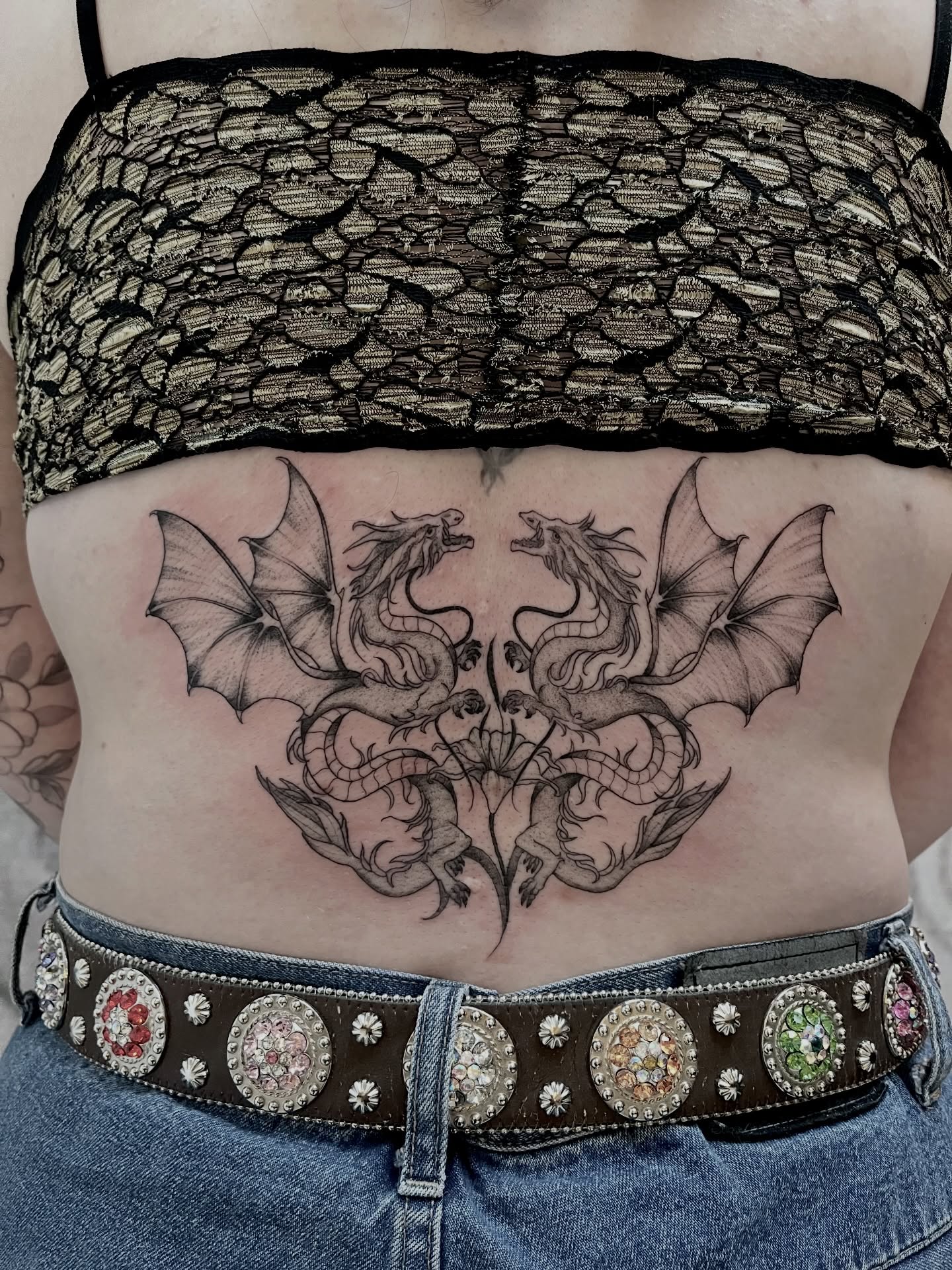 Dragons black and grey tattoo on the torso by Lo Gwynn