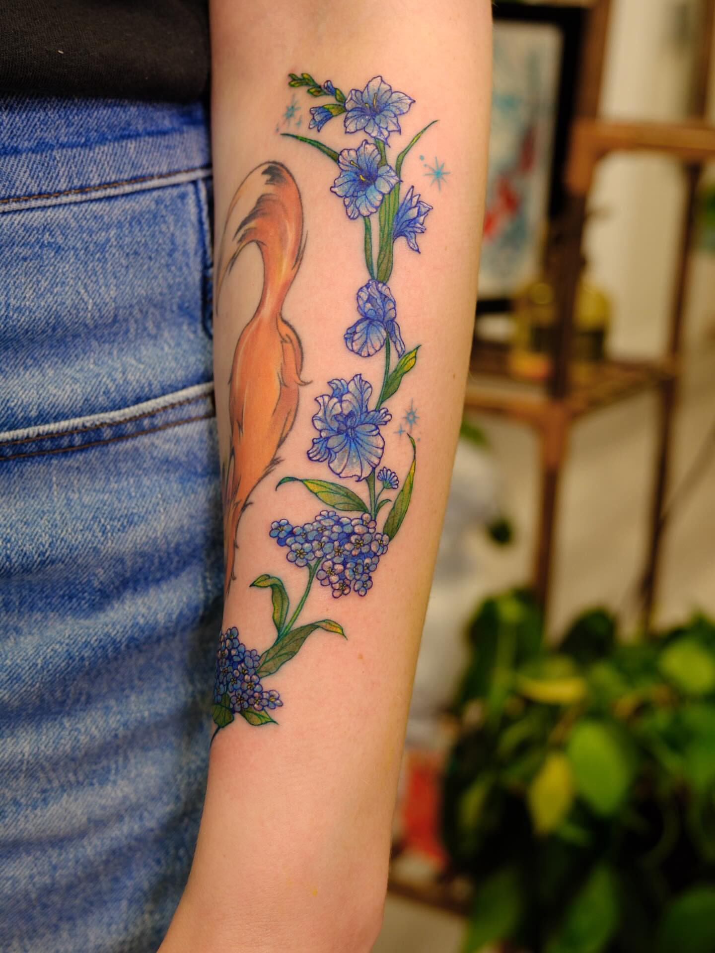Blue flowers and fox new school tattoo on the forearm by rita_tattooist