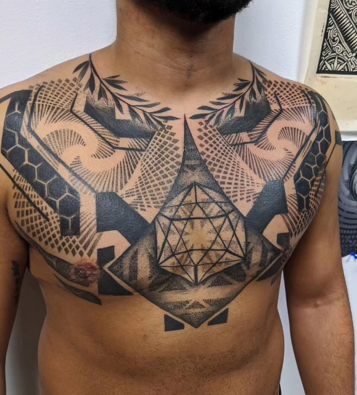 Geometric geometric tattoo on the chest by Ed Gonzalez