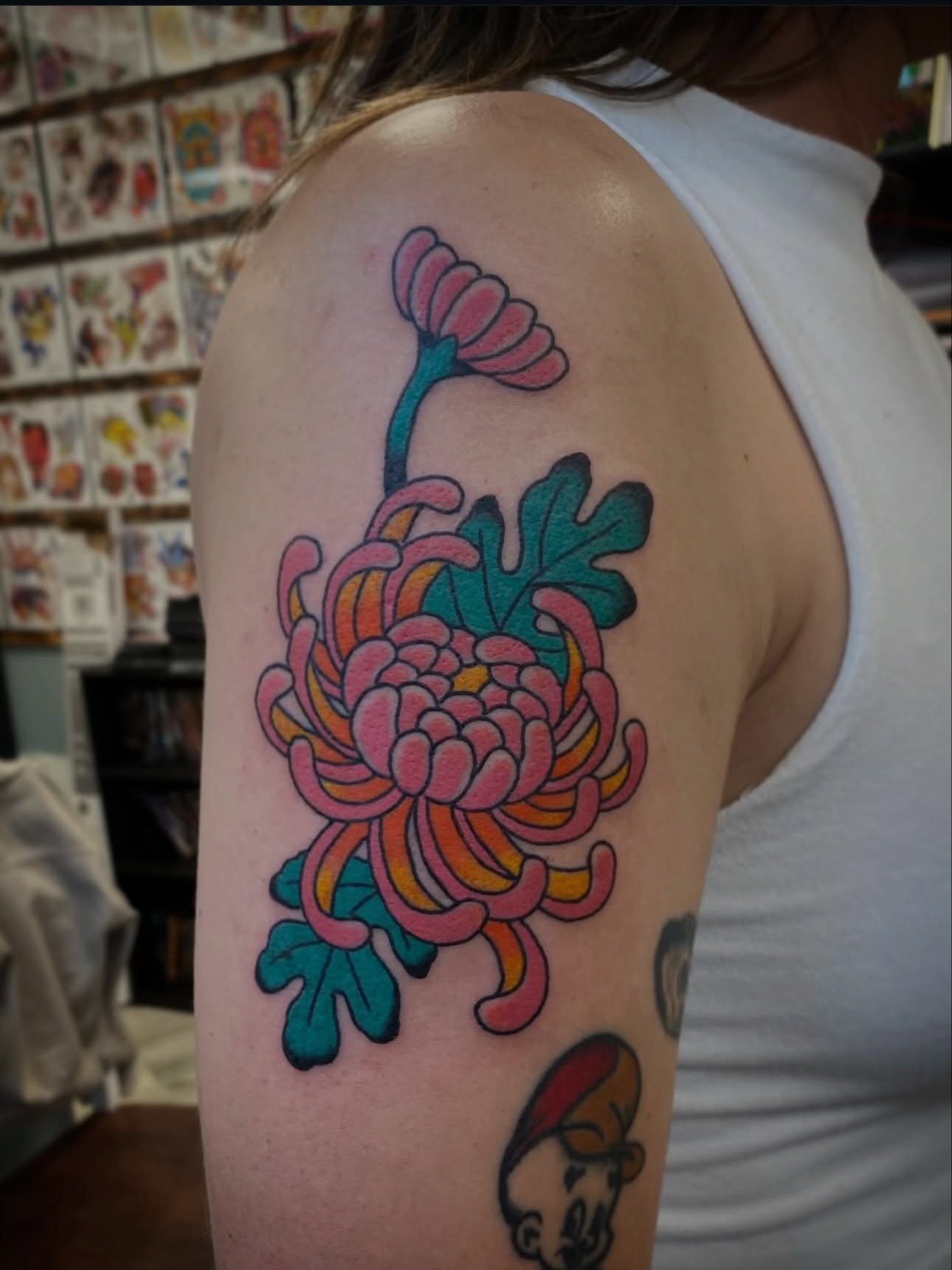 Chrysanthemum new school tattoo on the upper arm by Kyle Mitchell, Cincinnati