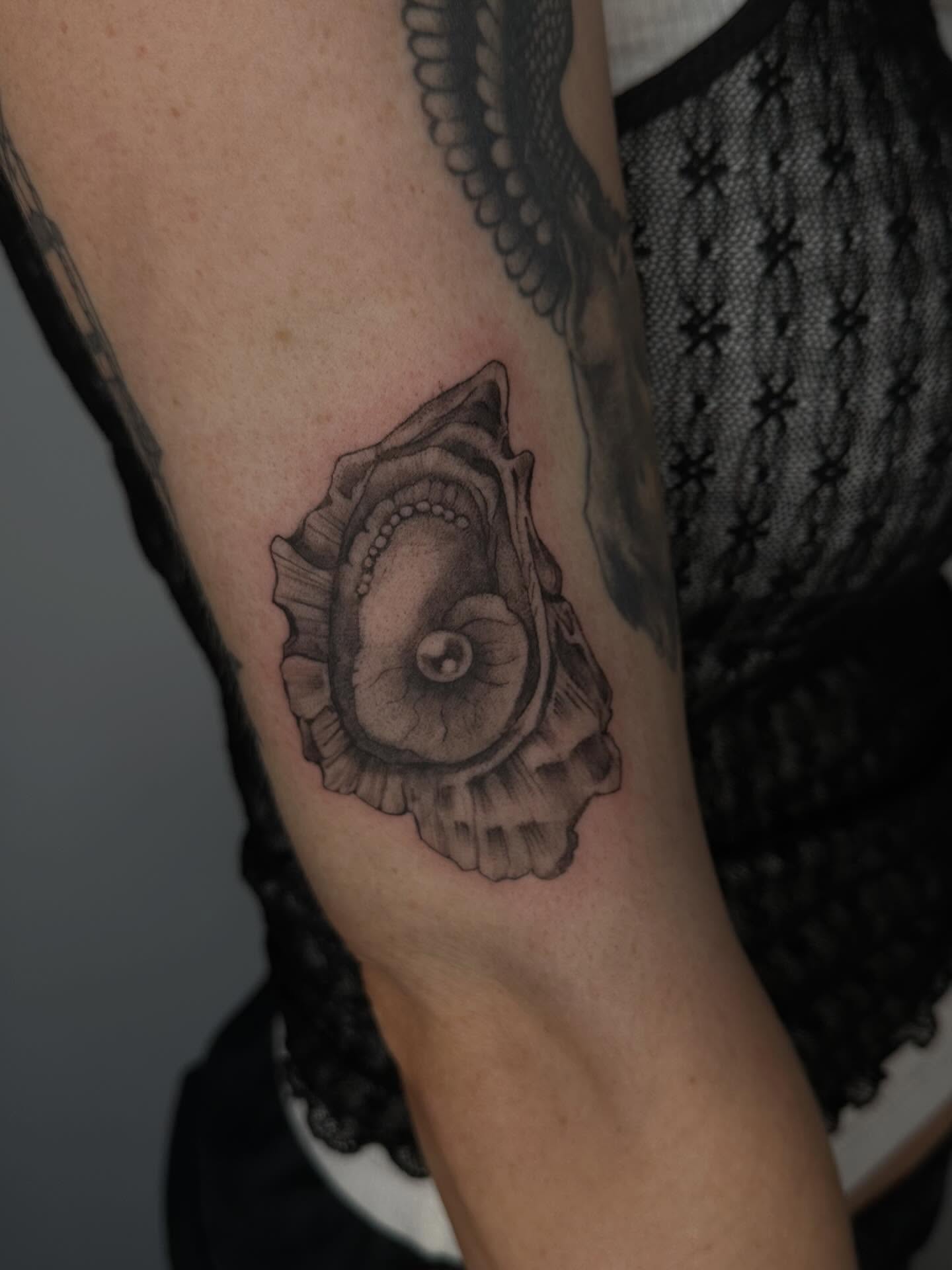 Shell black and grey tattoo on the forearm by Sadie Spades Philly Tattoos