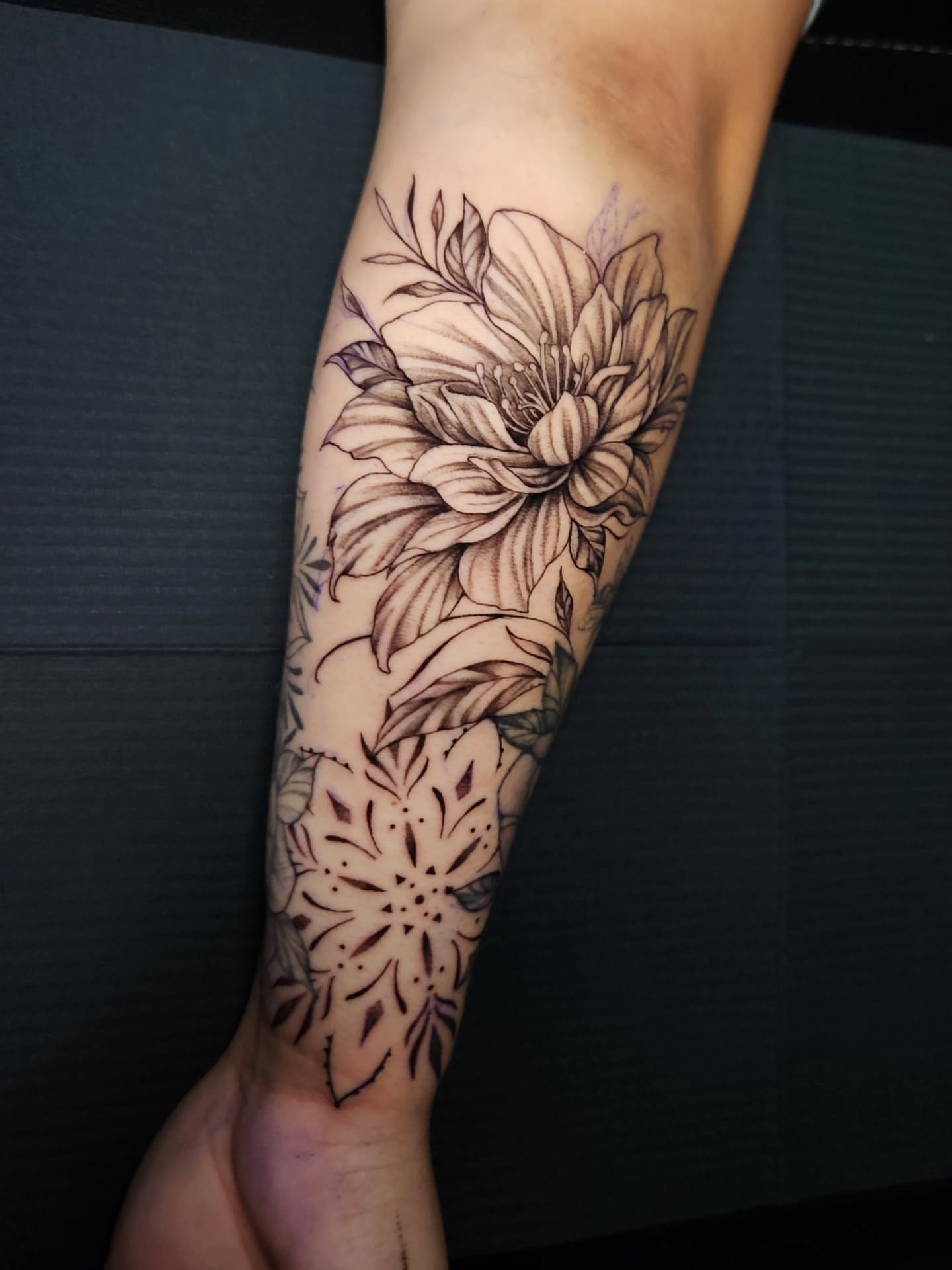 Floral bouquet black and grey tattoo on the forearm by Abby Renteria