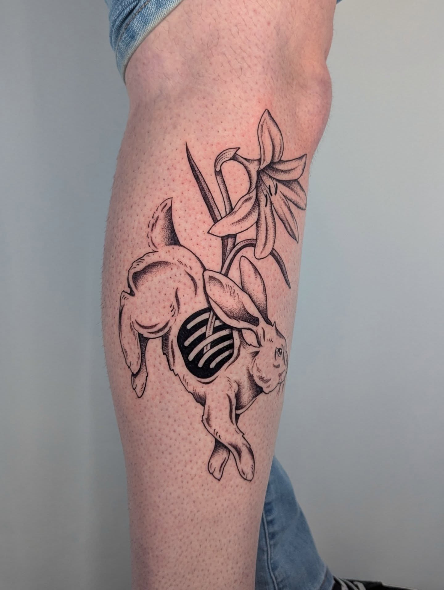 Rabbit and flowers dotwork tattoo on the forearm by Courtney Yaddof