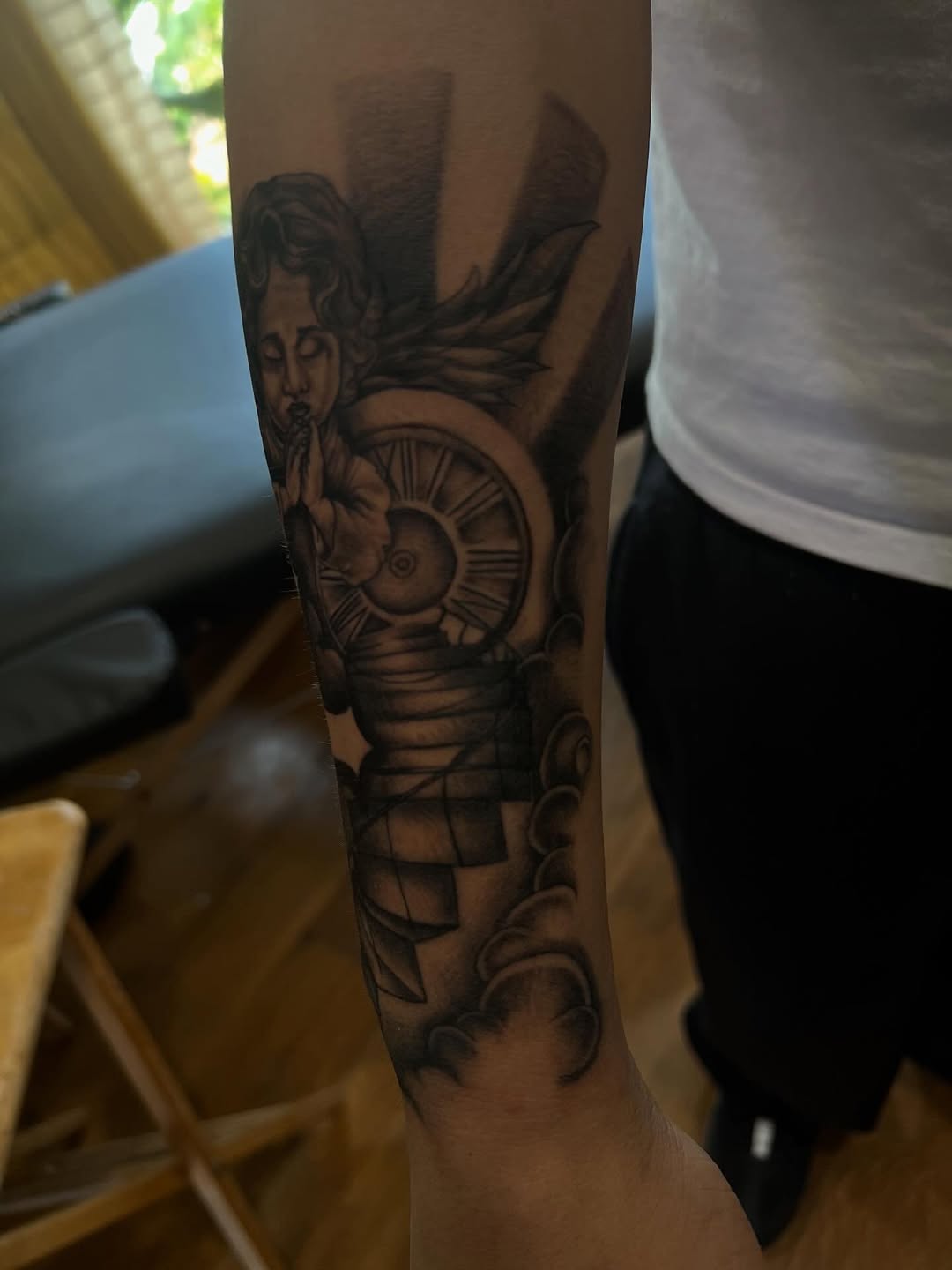 Angel and clock realism tattoo on the forearm by zion