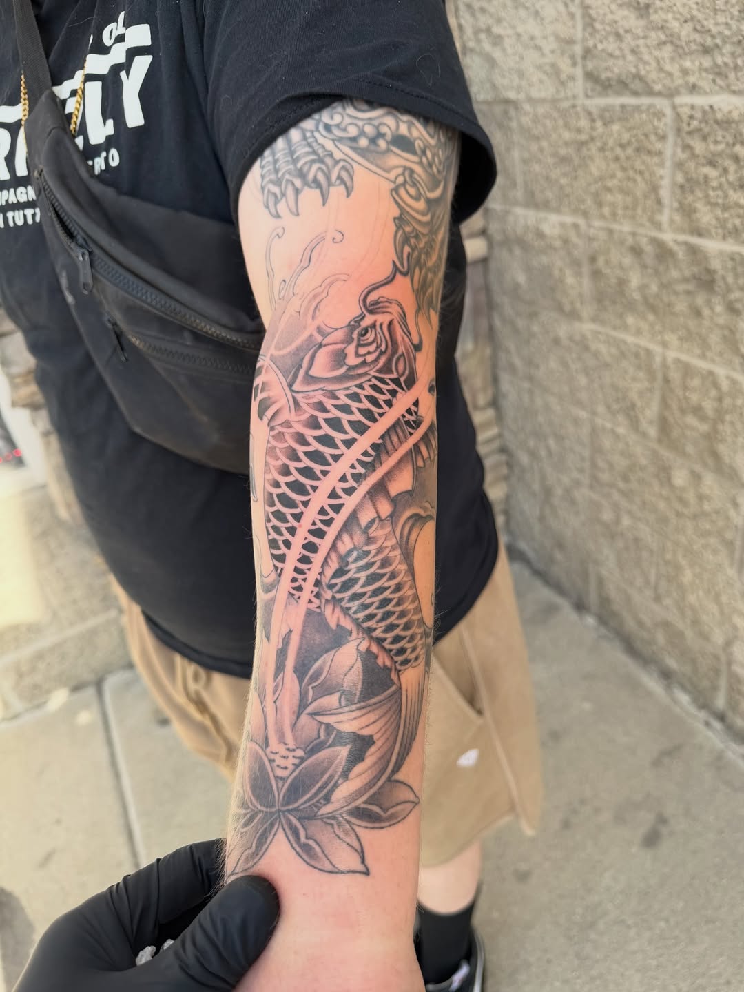Koi fish and lotus flower Japanese tattoo on the forearm by Winston Thai