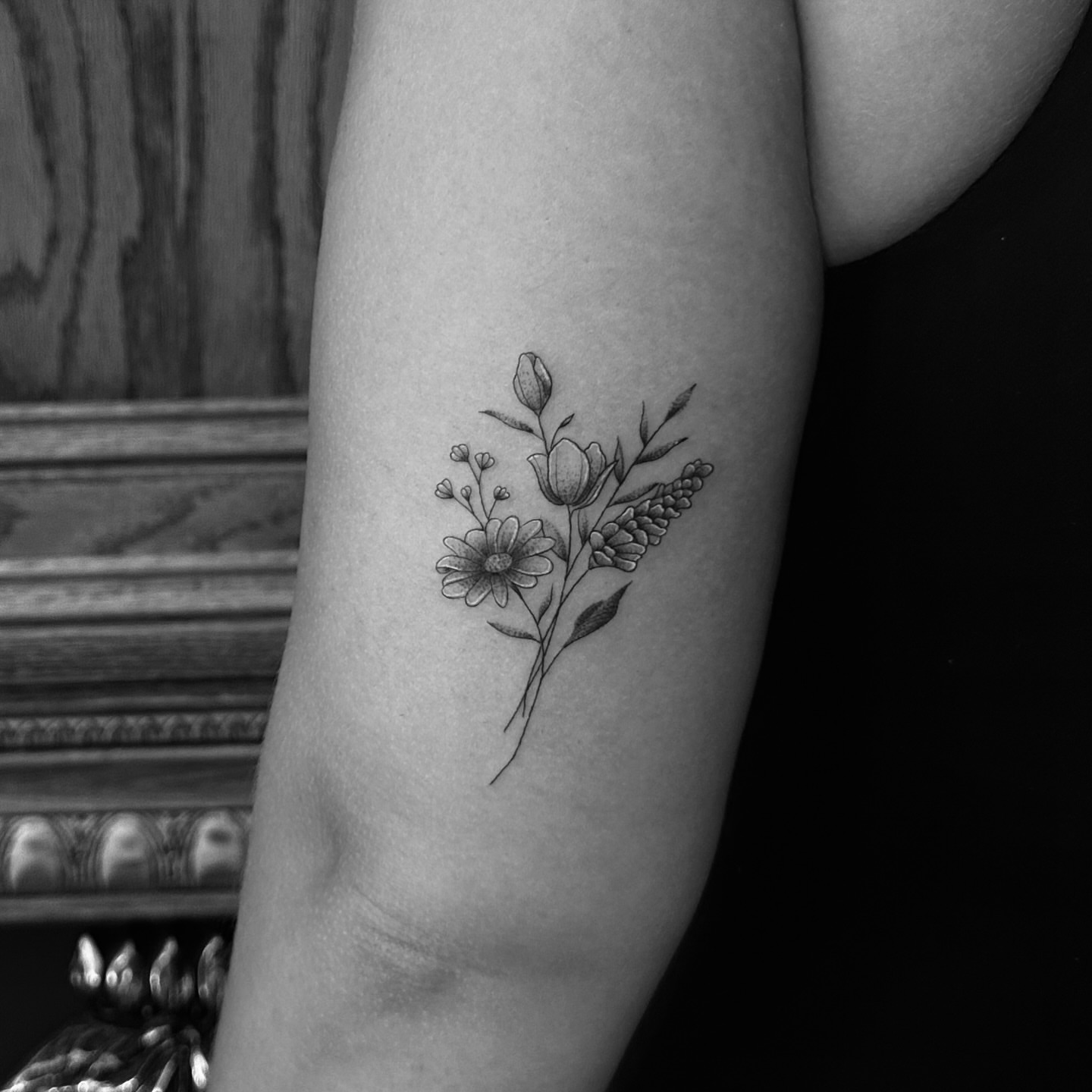Floral bouquet black and grey tattoo on the forearm by Leo Fernandes, Danvers, Massachusetts