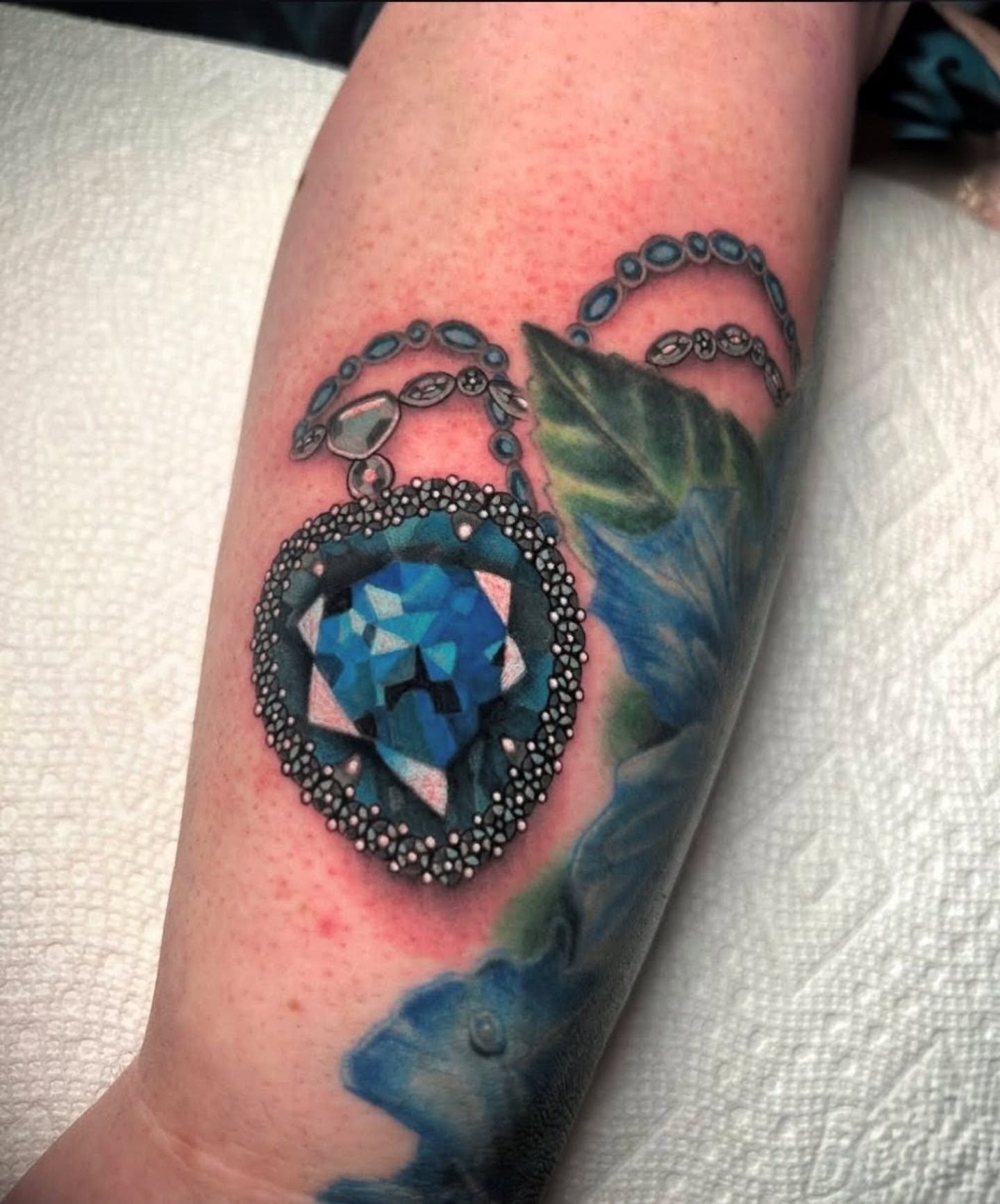Gemstone pendant geometric tattoo on the forearm by Chloe Marie