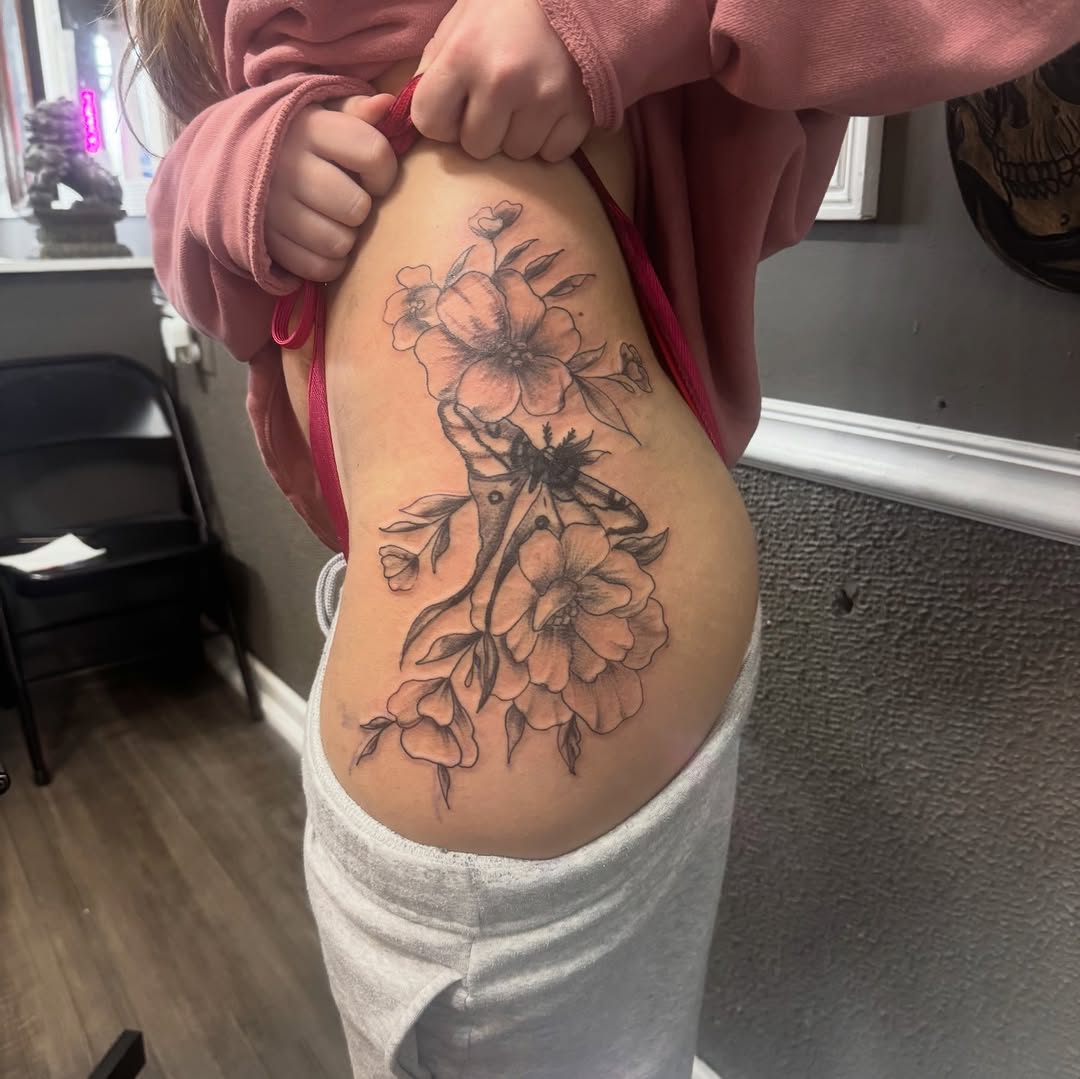Moth and flowers fine line tattoo on the thigh by Lexy