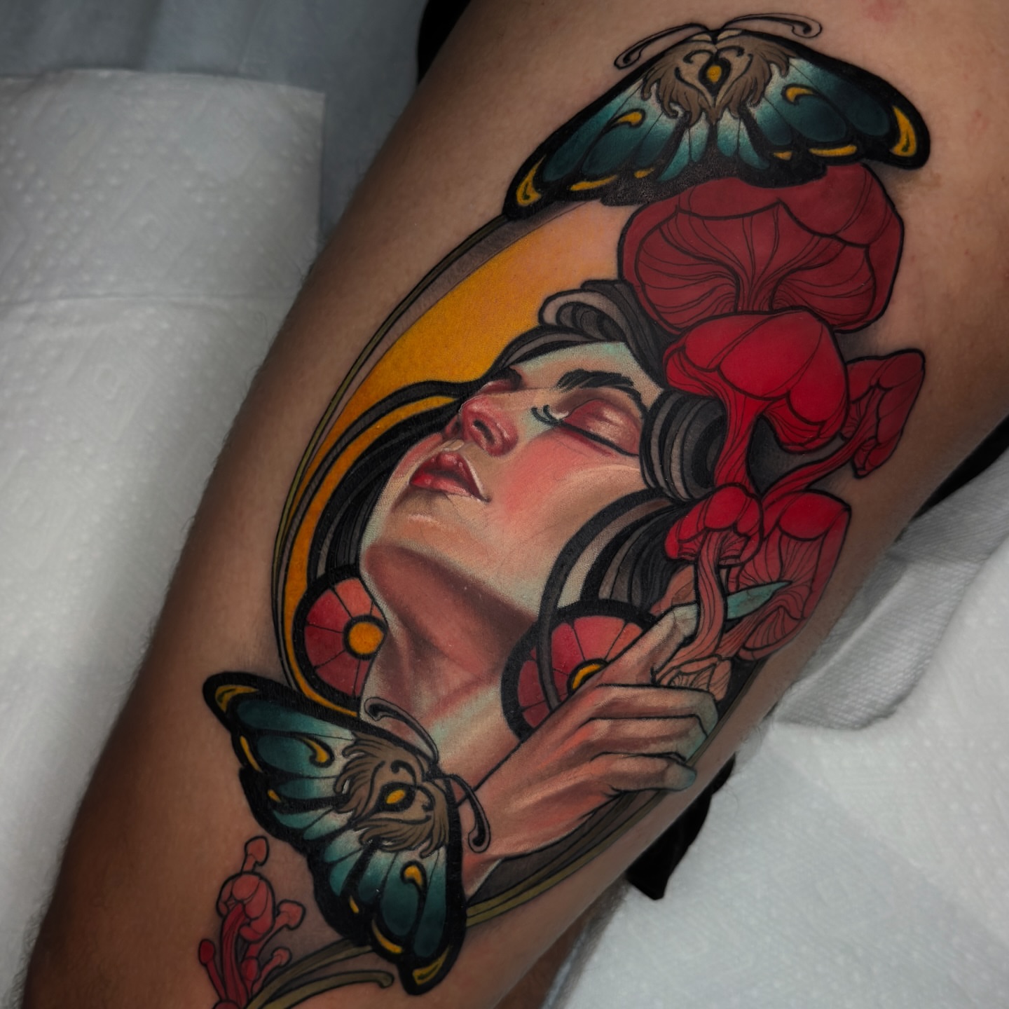 Woman with butterflies American traditional tattoo on the thigh by Golden Heart Tattoo Co