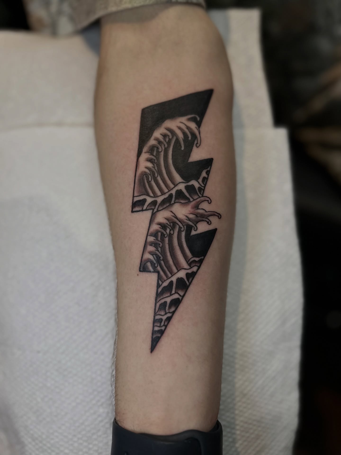 Wave and lightning bolt geometric tattoo on the forearm by Nick Weaver aka gibby sometimes gilbert