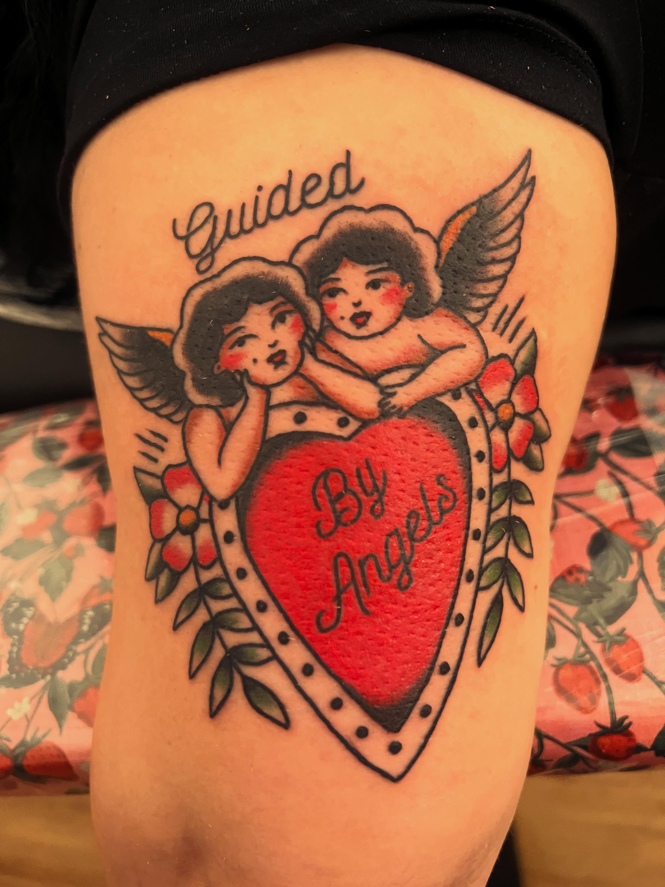 Angels and heart American traditional tattoo on the thigh by Samantha Citer