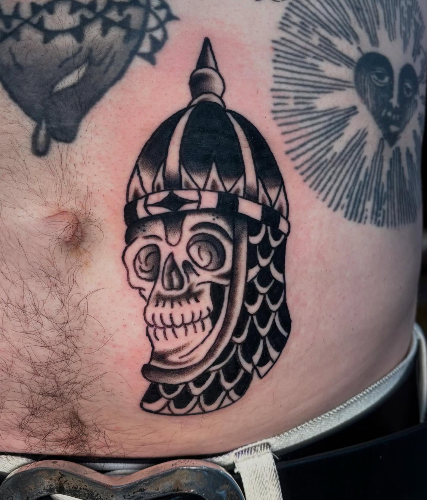 Viking helmet skull black and grey tattoo on the thigh by @spicy.curry.tattoos