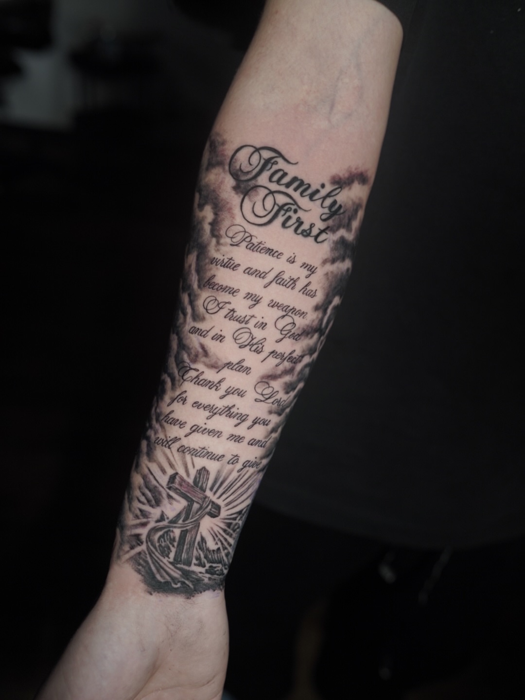Family motto black and grey tattoo on the forearm by Niko Hosk Cataldo