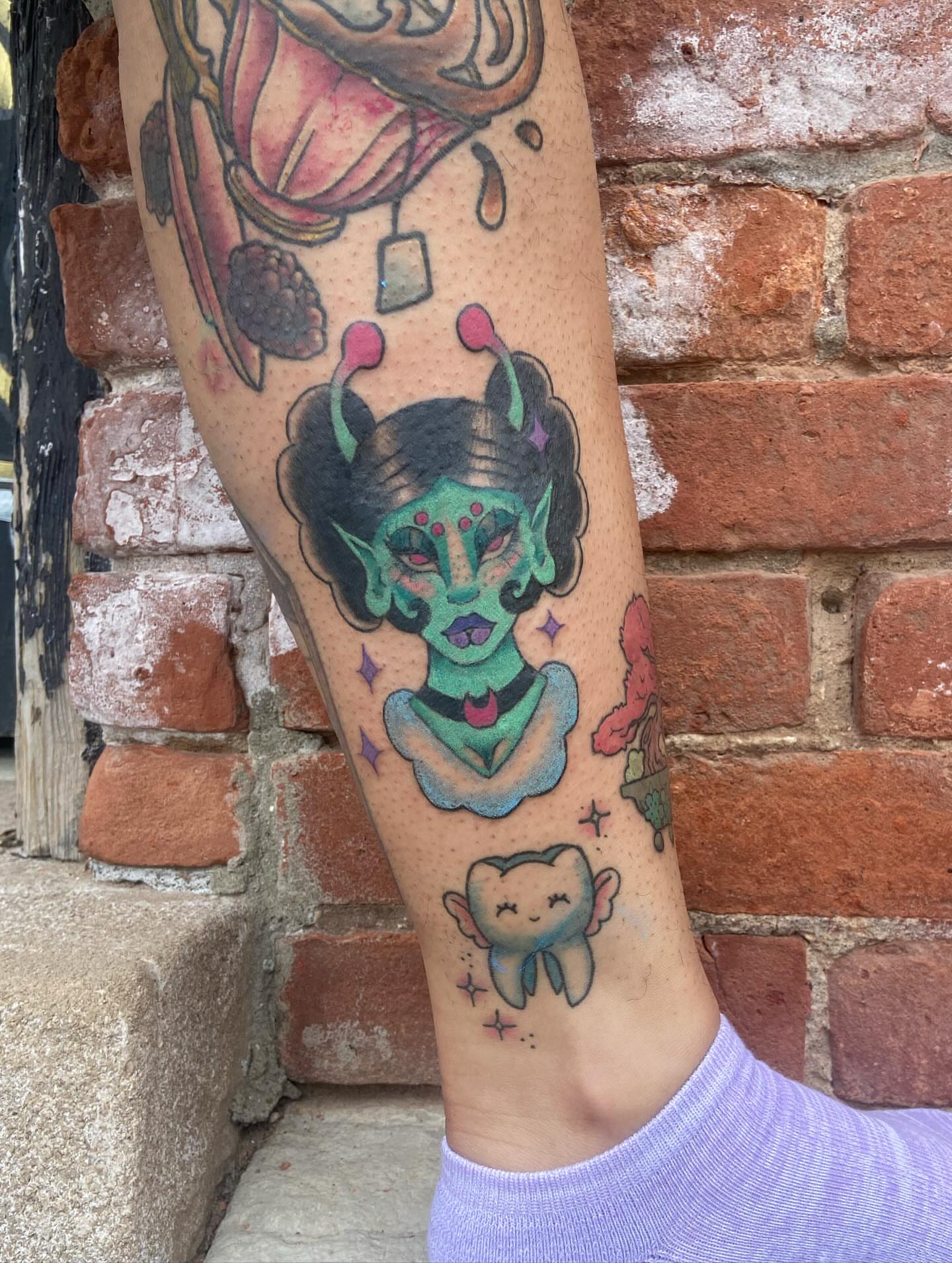 Alien American traditional tattoo on the forearm by 🐆Cam Feral Tattoos