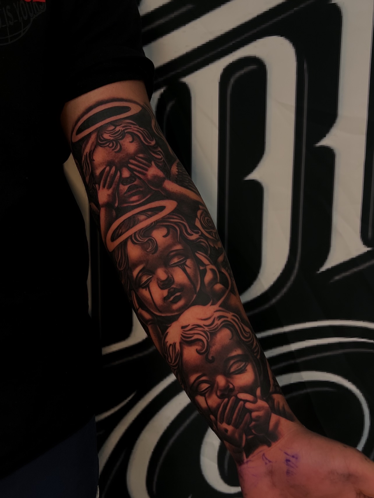 Angels realism tattoo on the forearm by Daniel Michael Perez