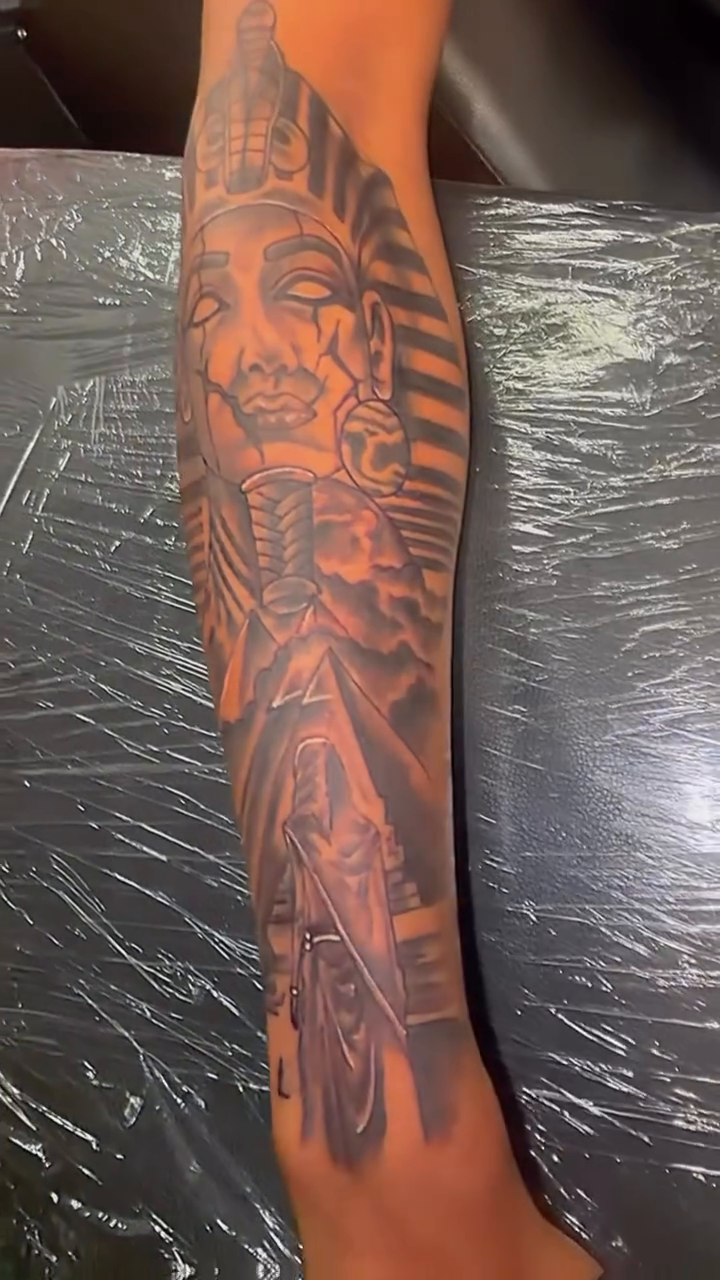 Pharaoh's head with intricate details realism tattoo on the upper arm by Marcus Carter