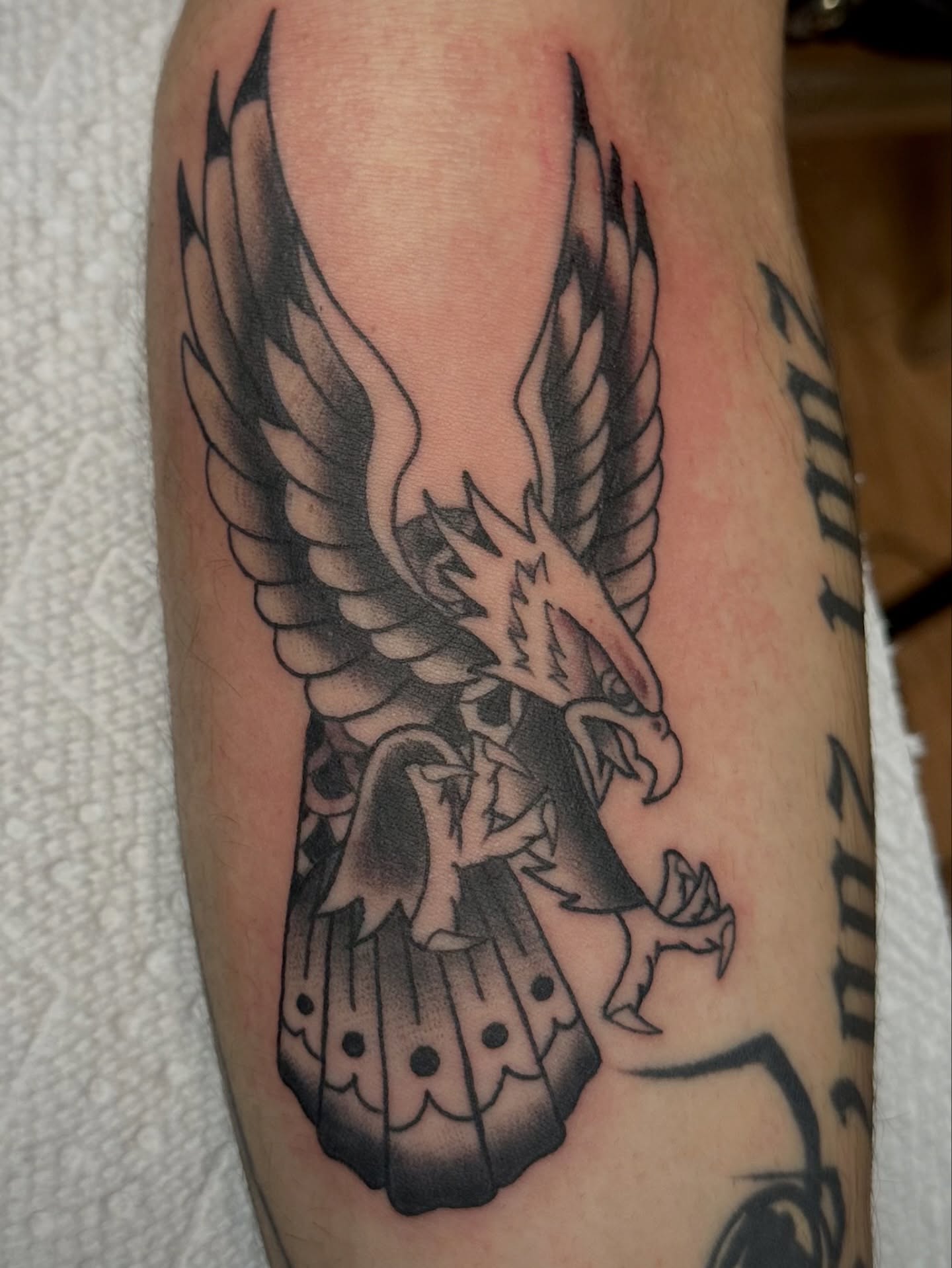 Eagle black and grey tattoo on the forearm by Josh Robinson
