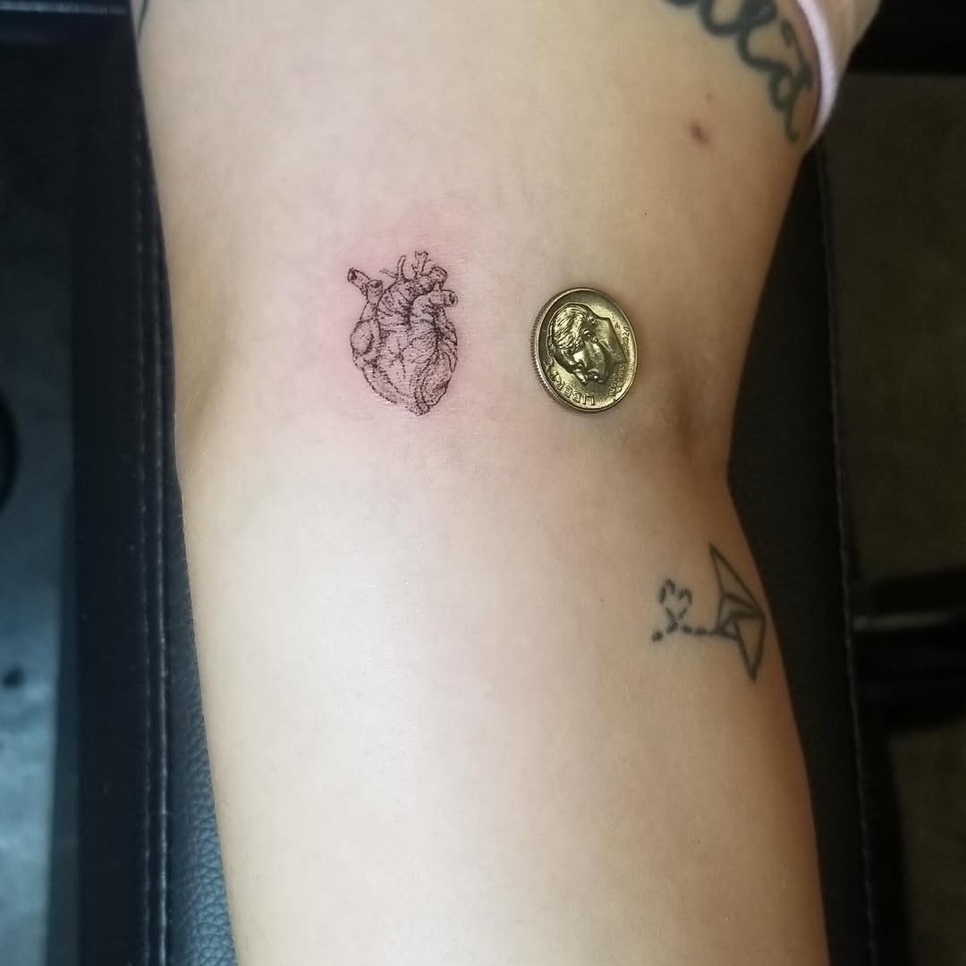 Anatomical heart minimalist tattoo on the forearm by Gisette Gomez