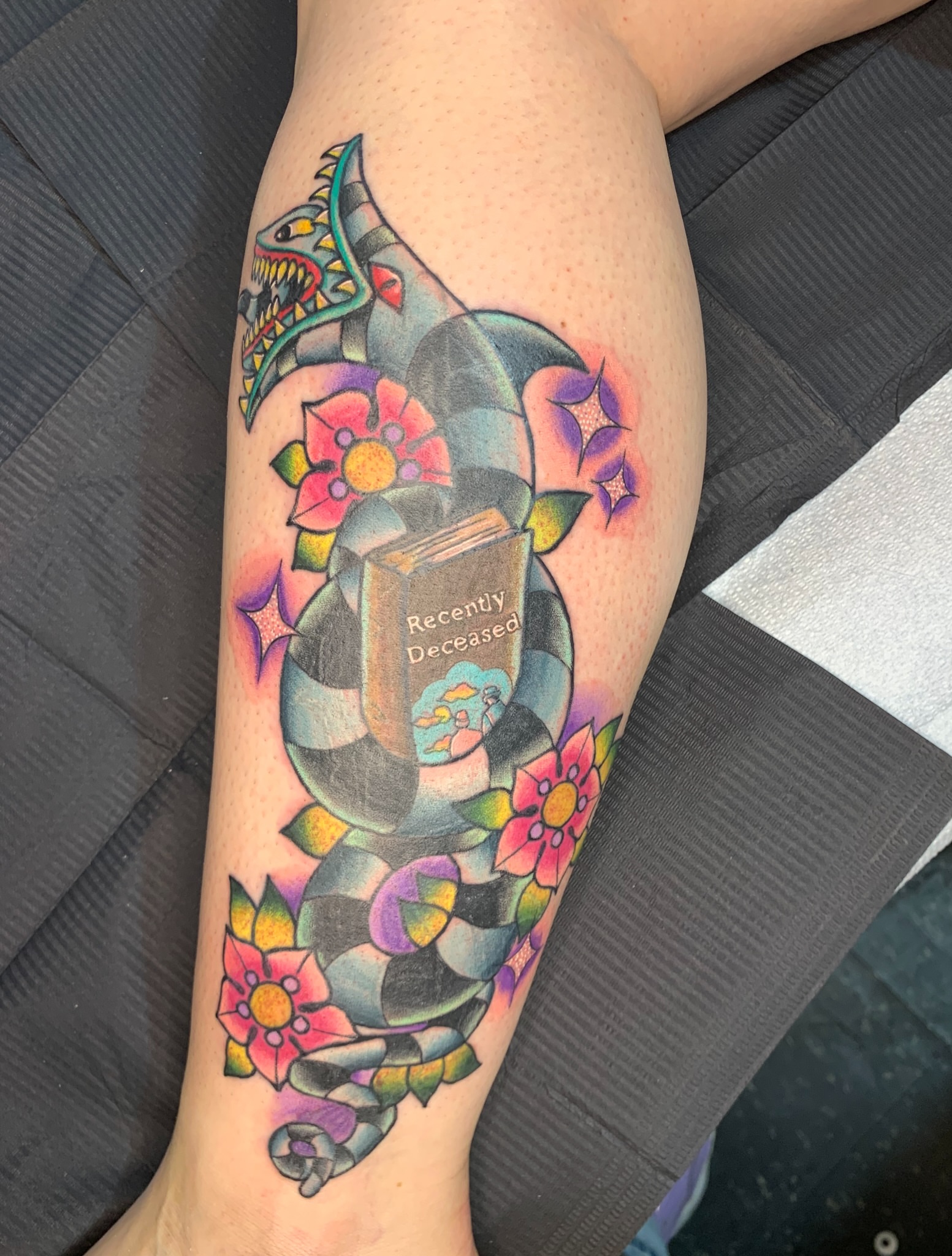 Book with 'Recently Deceased' American traditional tattoo on the forearm by Aubrianna Grisez