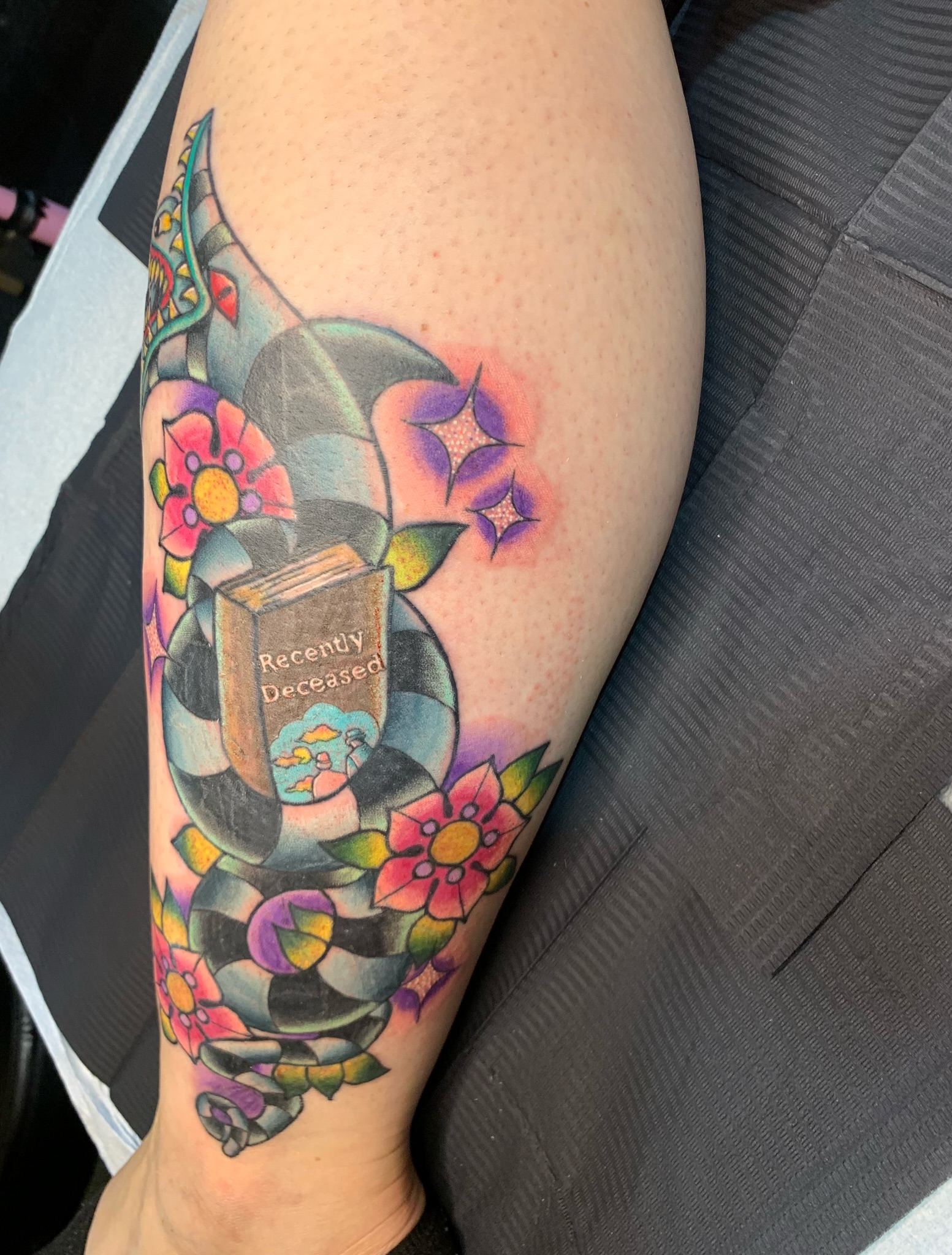Book with 'Recently Deceased' American traditional tattoo on the forearm by Aubrianna Grisez