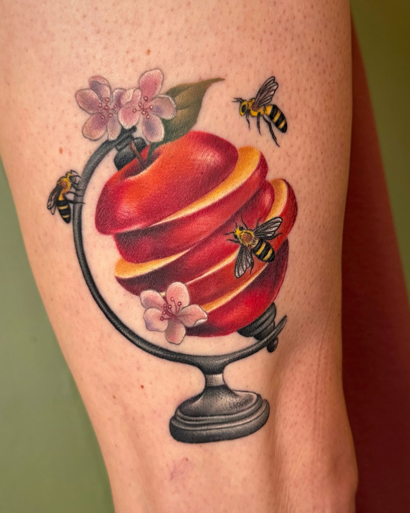 Apple slices realism tattoo on the forearm by Nichole Lorence
