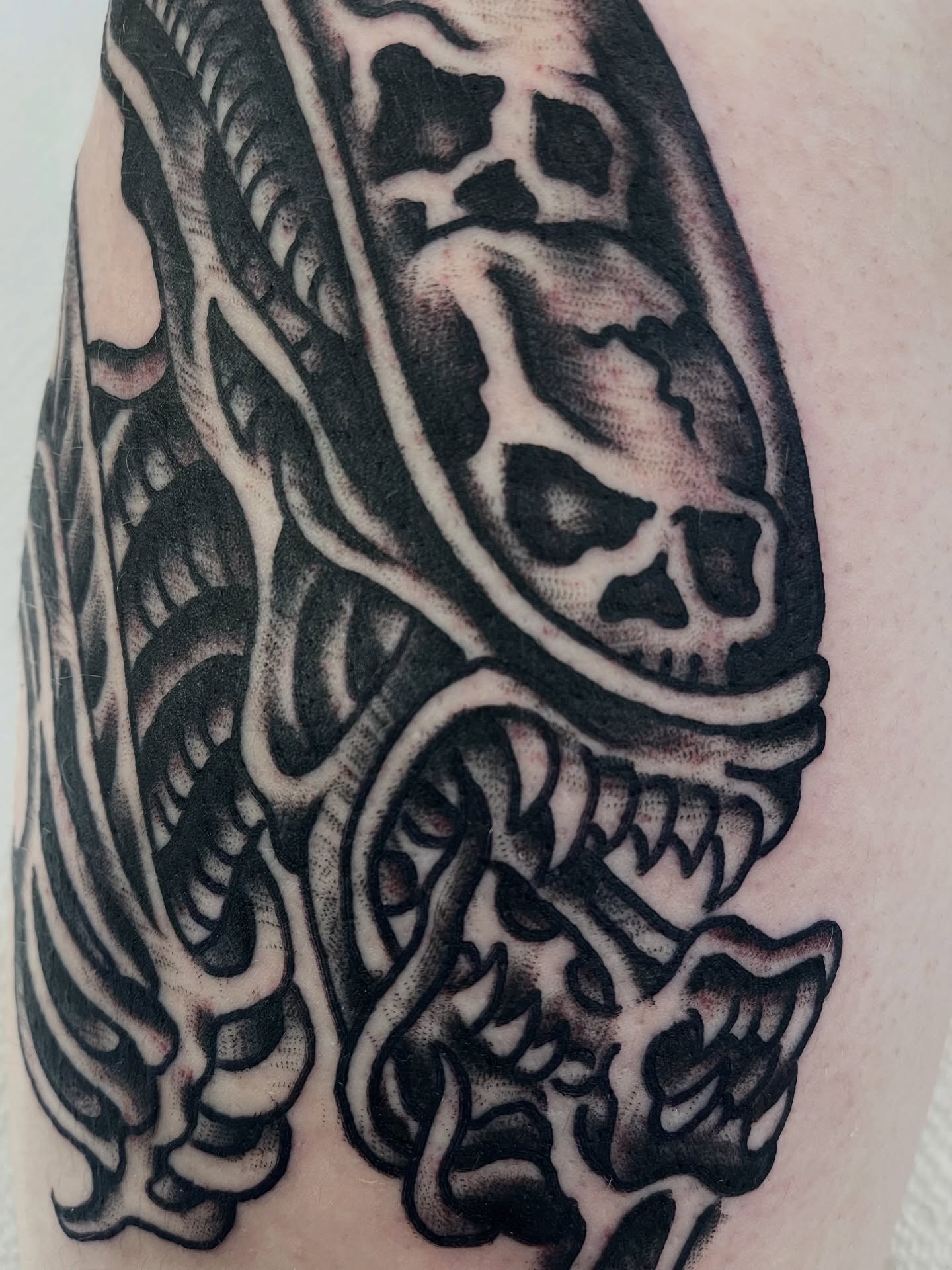Alien xenomorph dark realism tattoo on the upper arm by Alex Garcia - Sac City Tattoo