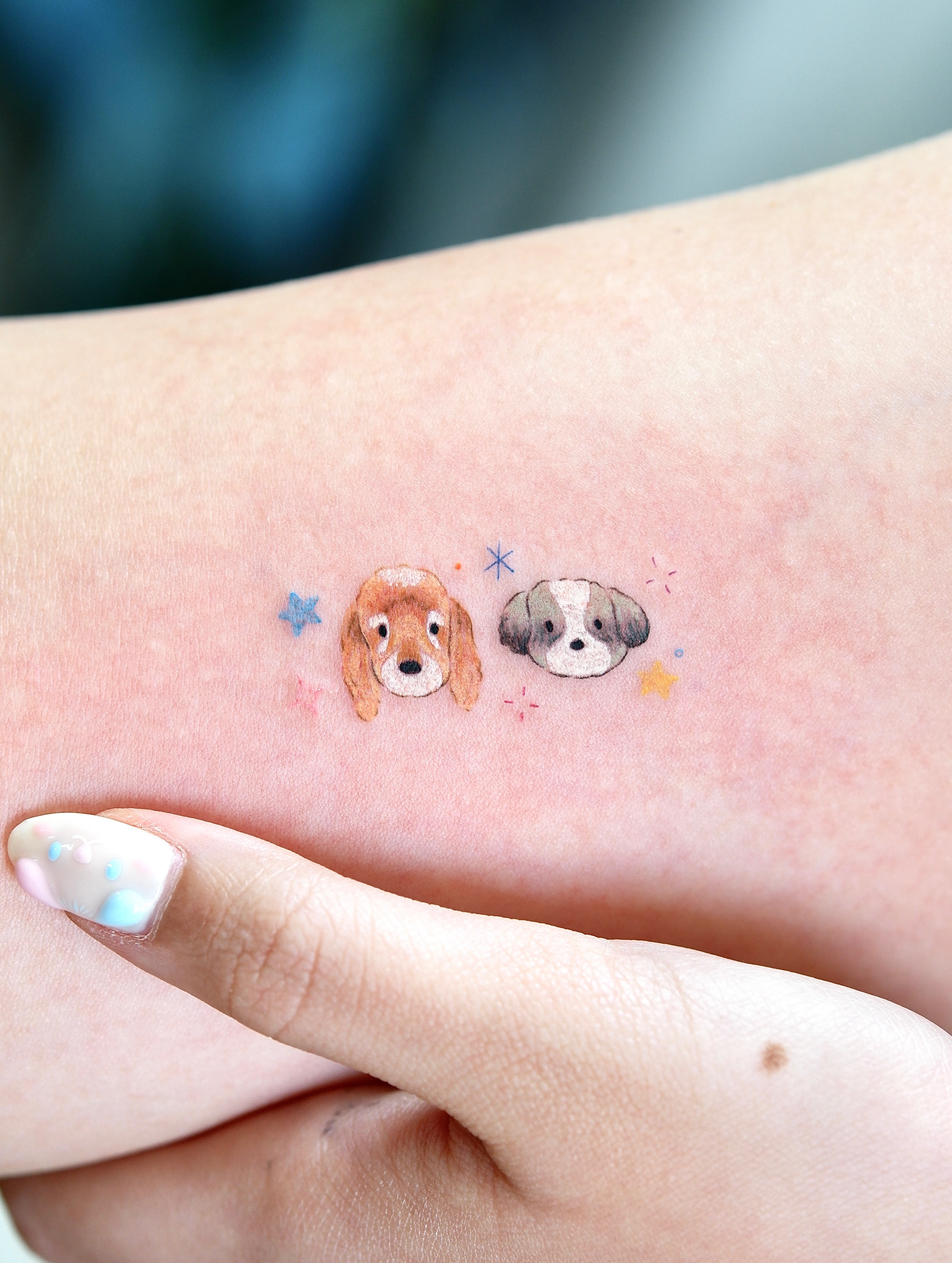 Two dogs watercolor tattoo on the forearm by 타투 Seon 컬러타투