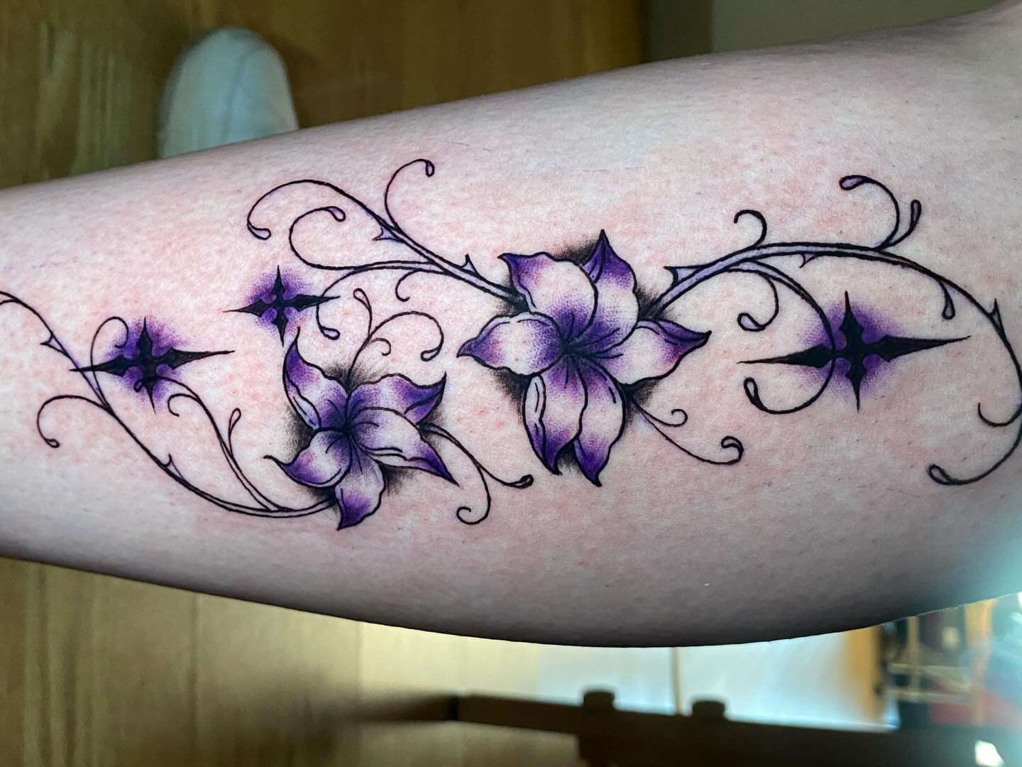 Purple flowers ornamental tattoo on the forearm by Laura🦋