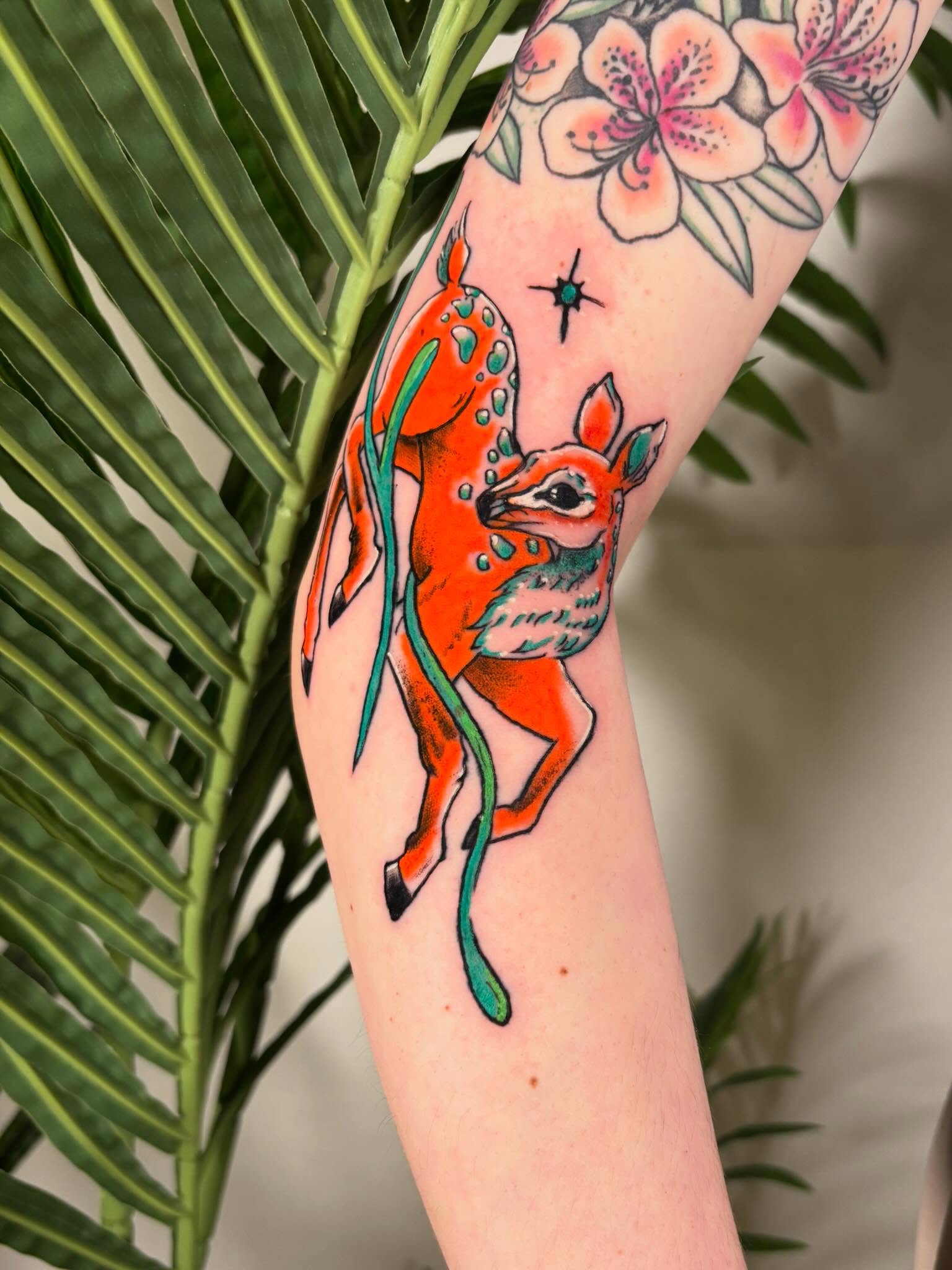 Deer and flowers American traditional tattoo on the forearm by Davie Tattoos