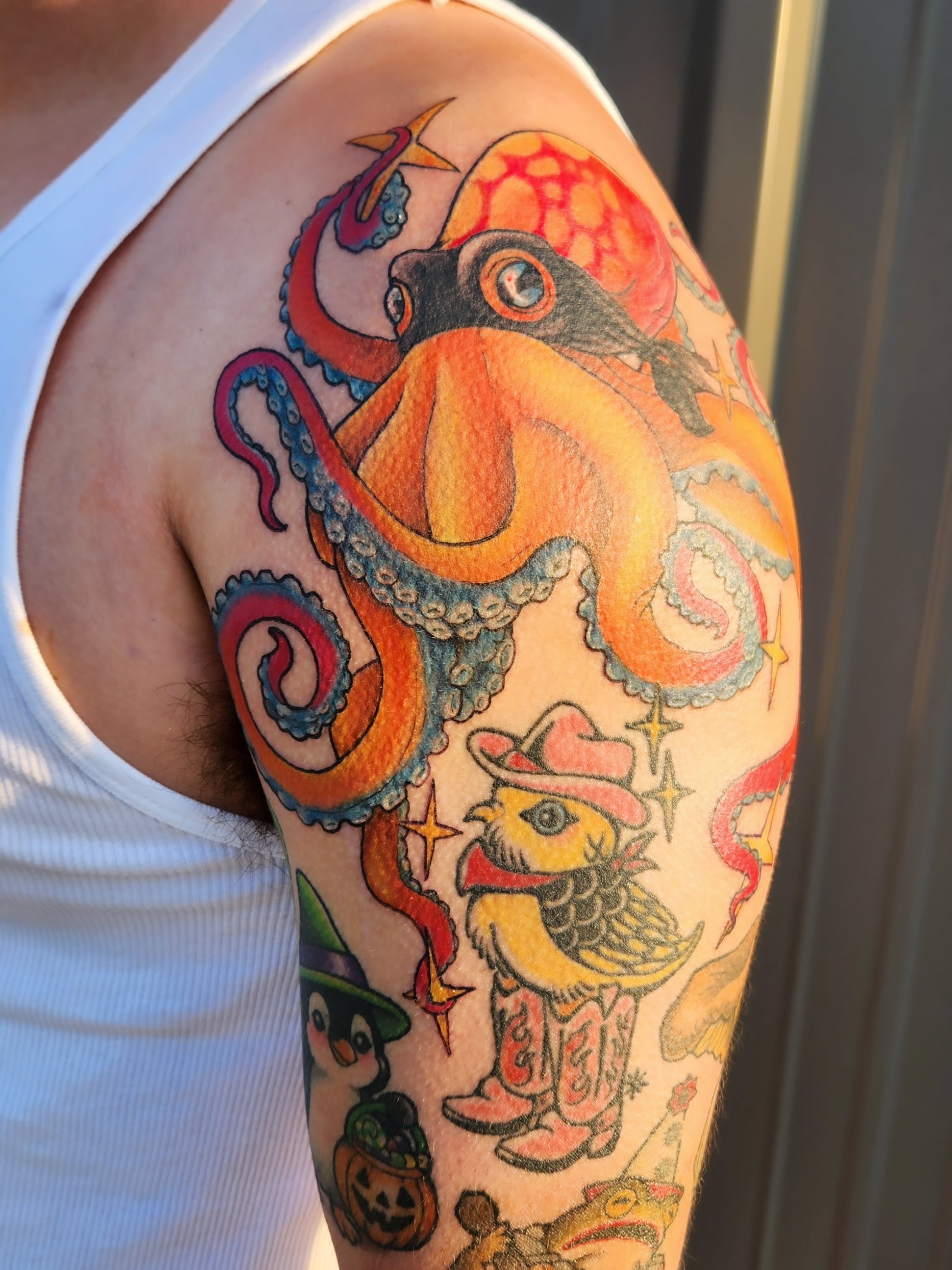 Octopus and bird American traditional tattoo on the upper arm by Amanda Boyd - Duh!