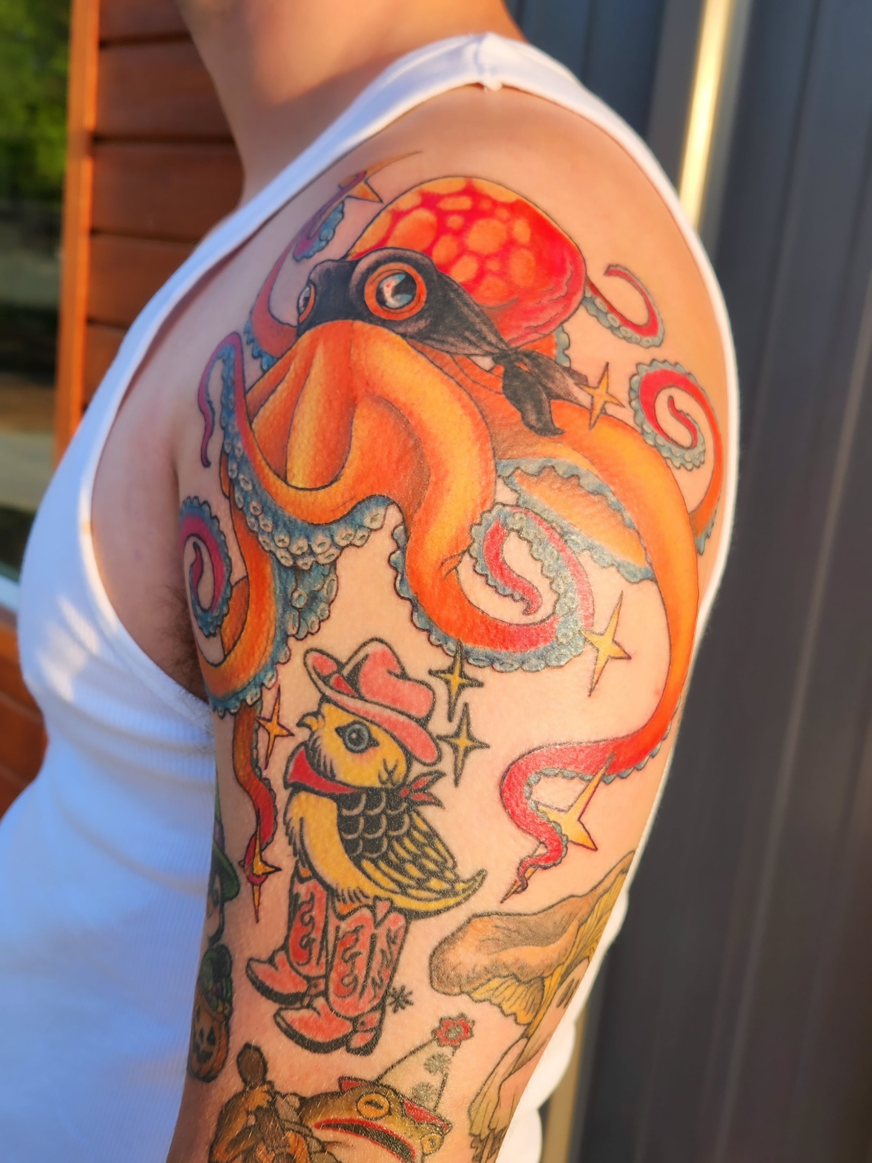 Octopus and bird American traditional tattoo on the upper arm by Amanda Boyd - Duh!