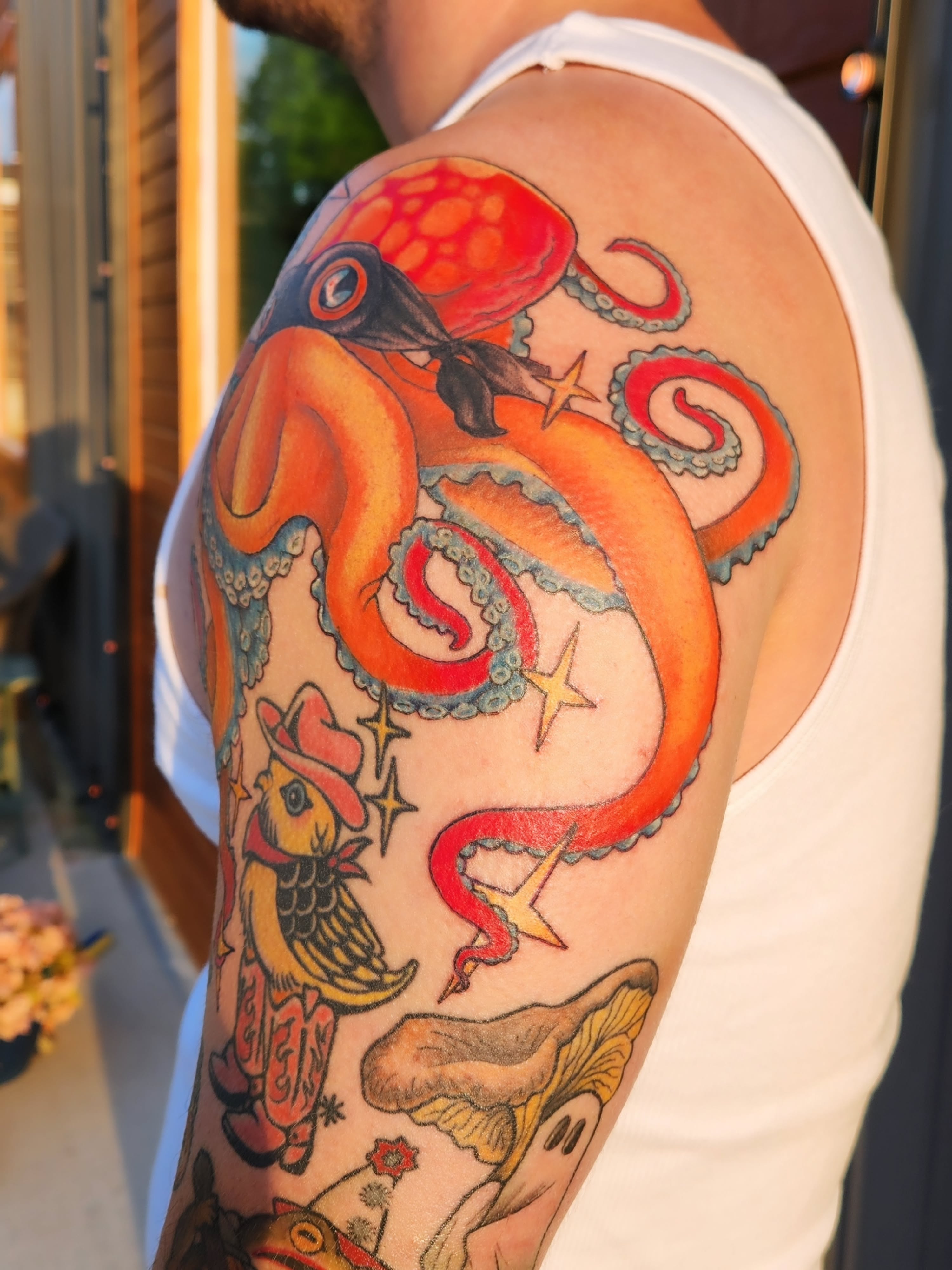 Octopus and fish American traditional tattoo on the upper arm by Amanda Boyd - Duh!