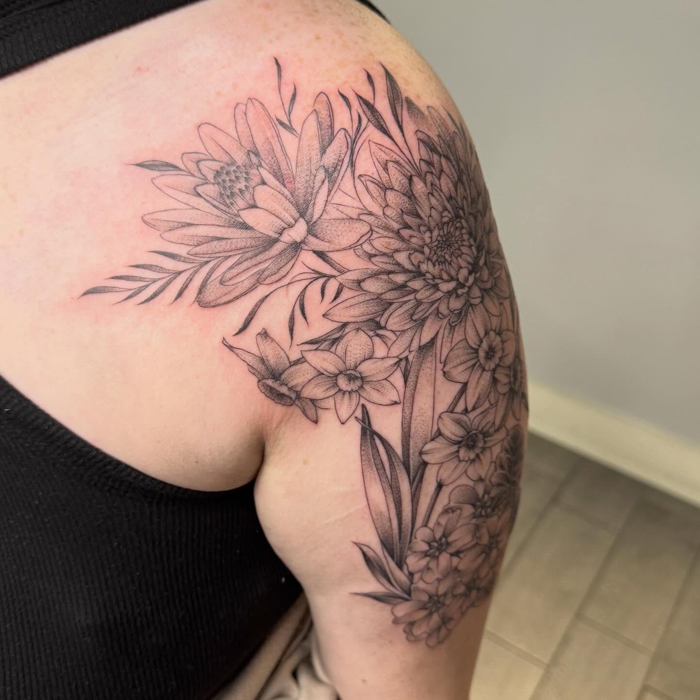 Floral bouquet dotwork tattoo on the shoulder by Joey Flaherty