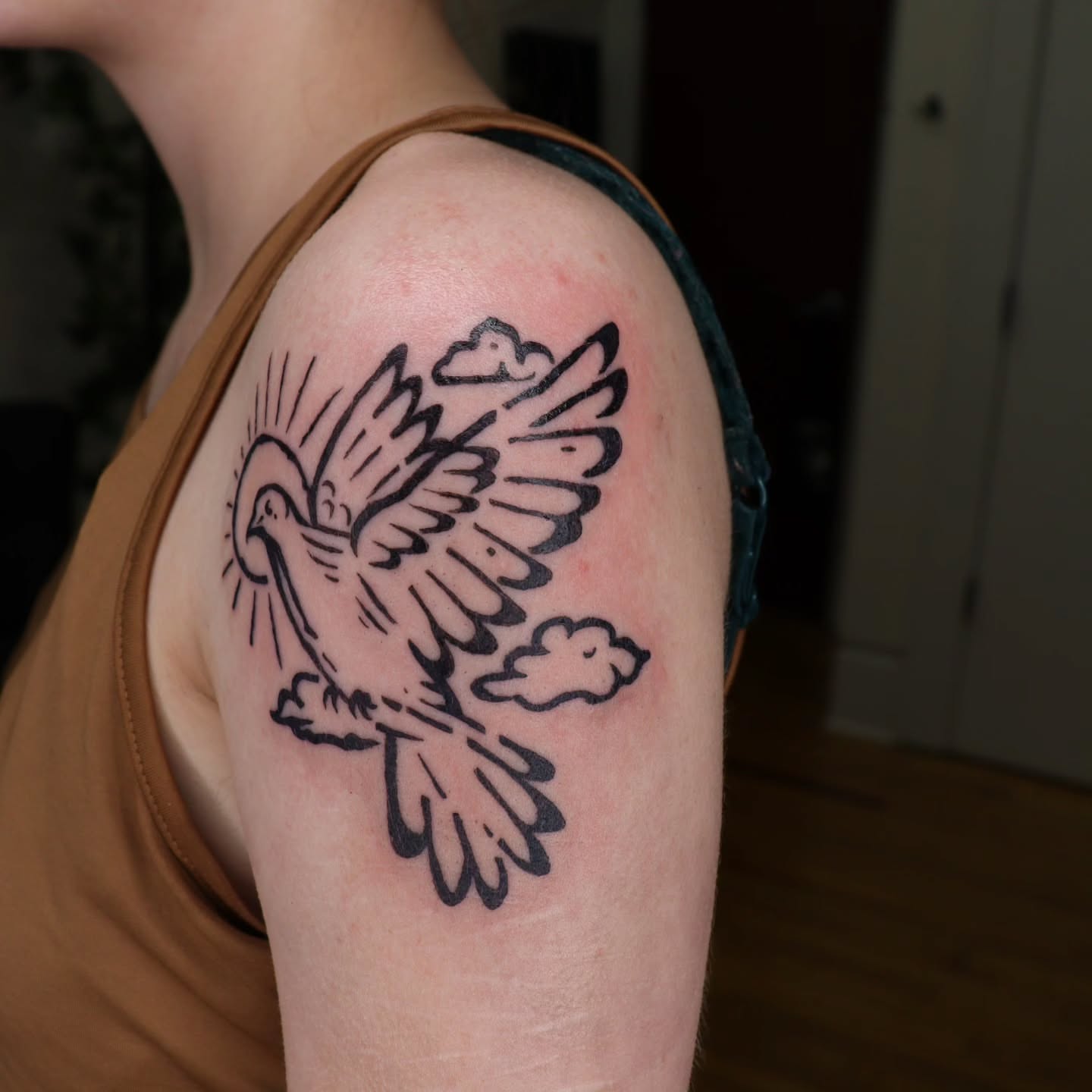 Dove American traditional tattoo on the shoulder by Veronika Lipchak