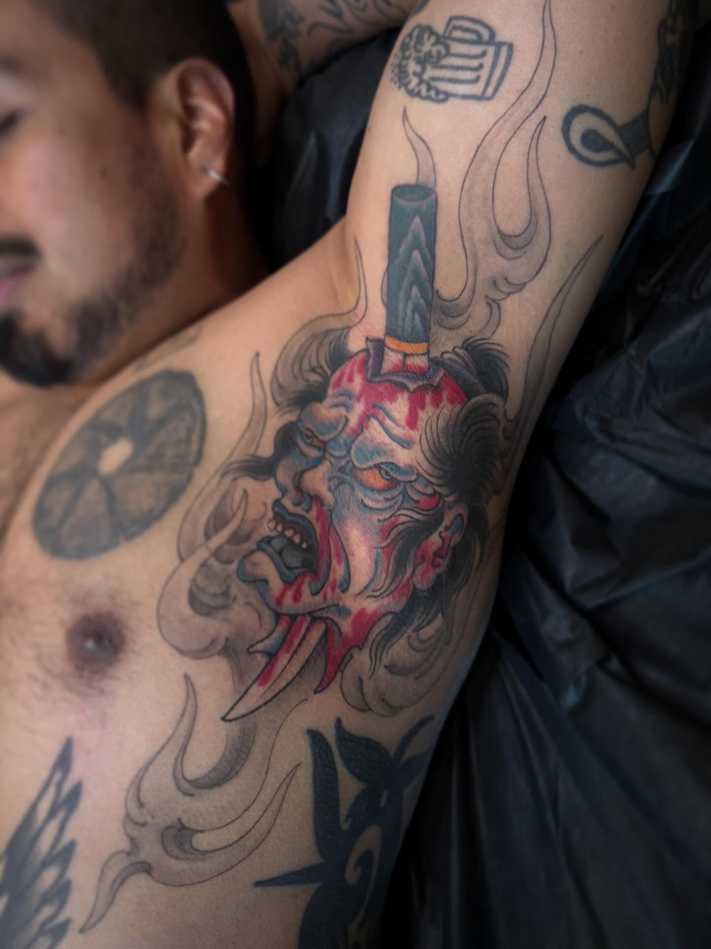 Demon mask with sword japanese irezumi tattoo on the forearm by Candi Kinyōbi