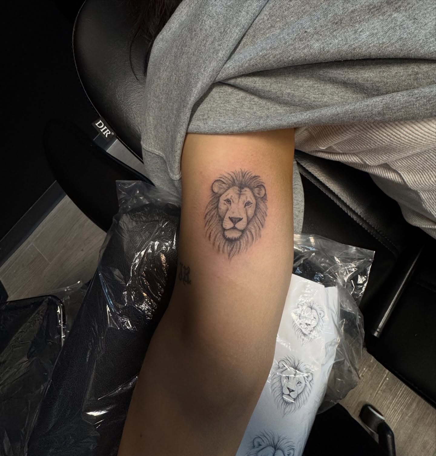 Lion black and grey tattoo on the forearm by Ryleigh Benjamin