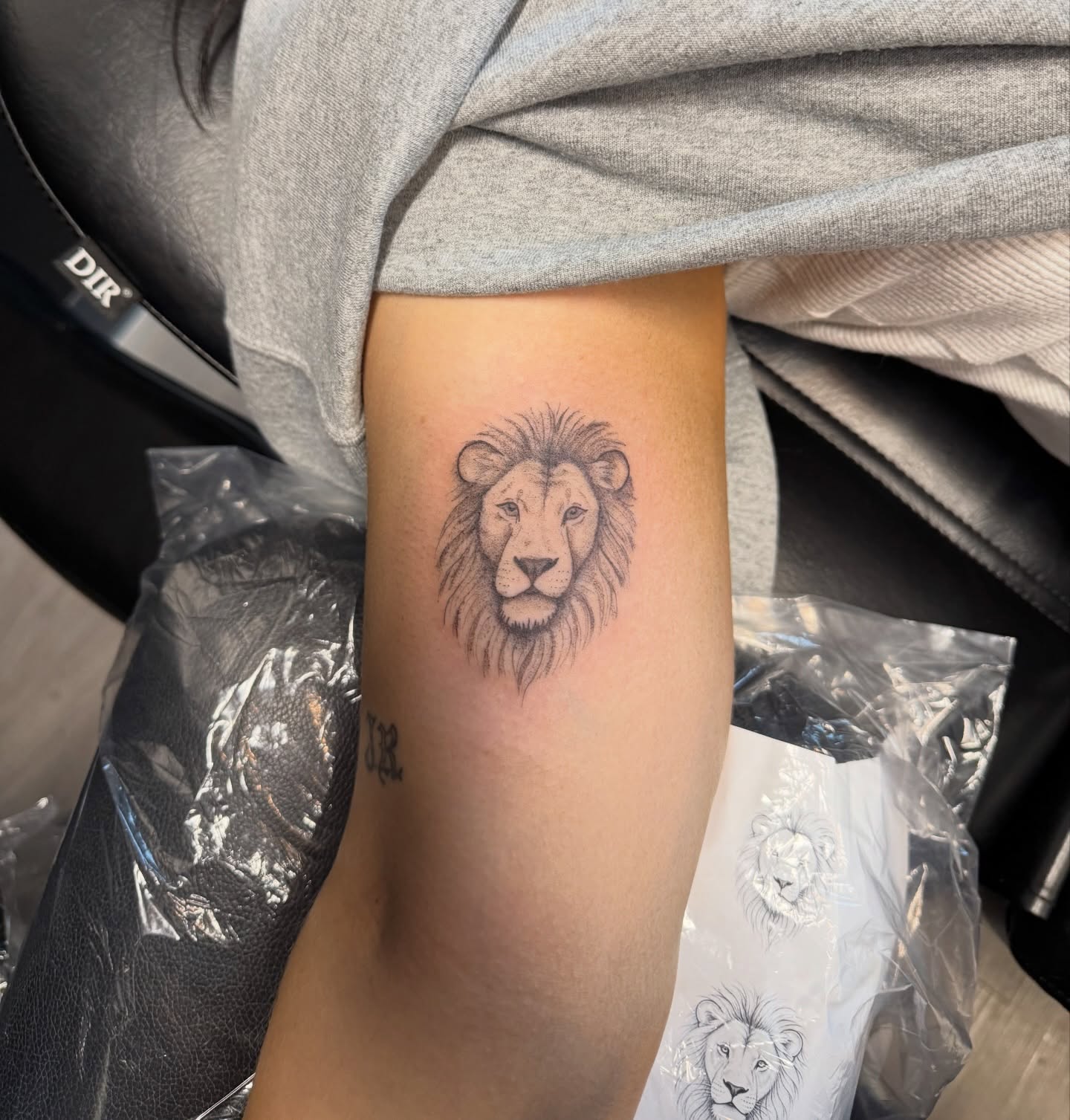 Lion black and grey tattoo on the forearm by Ryleigh Benjamin