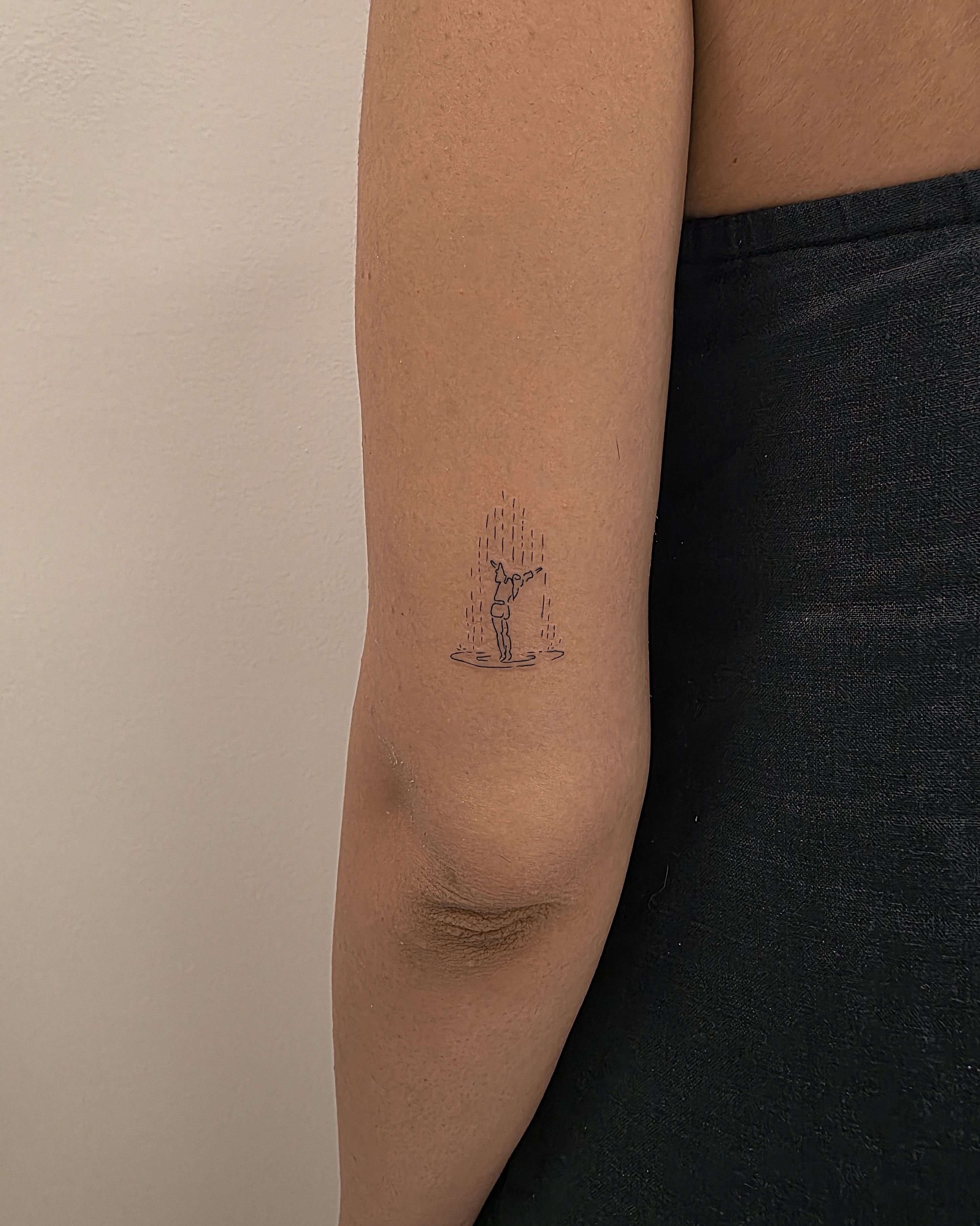 Raindrop minimalist tattoo on the forearm by Richmond tattoo shop, Richmond, Texas