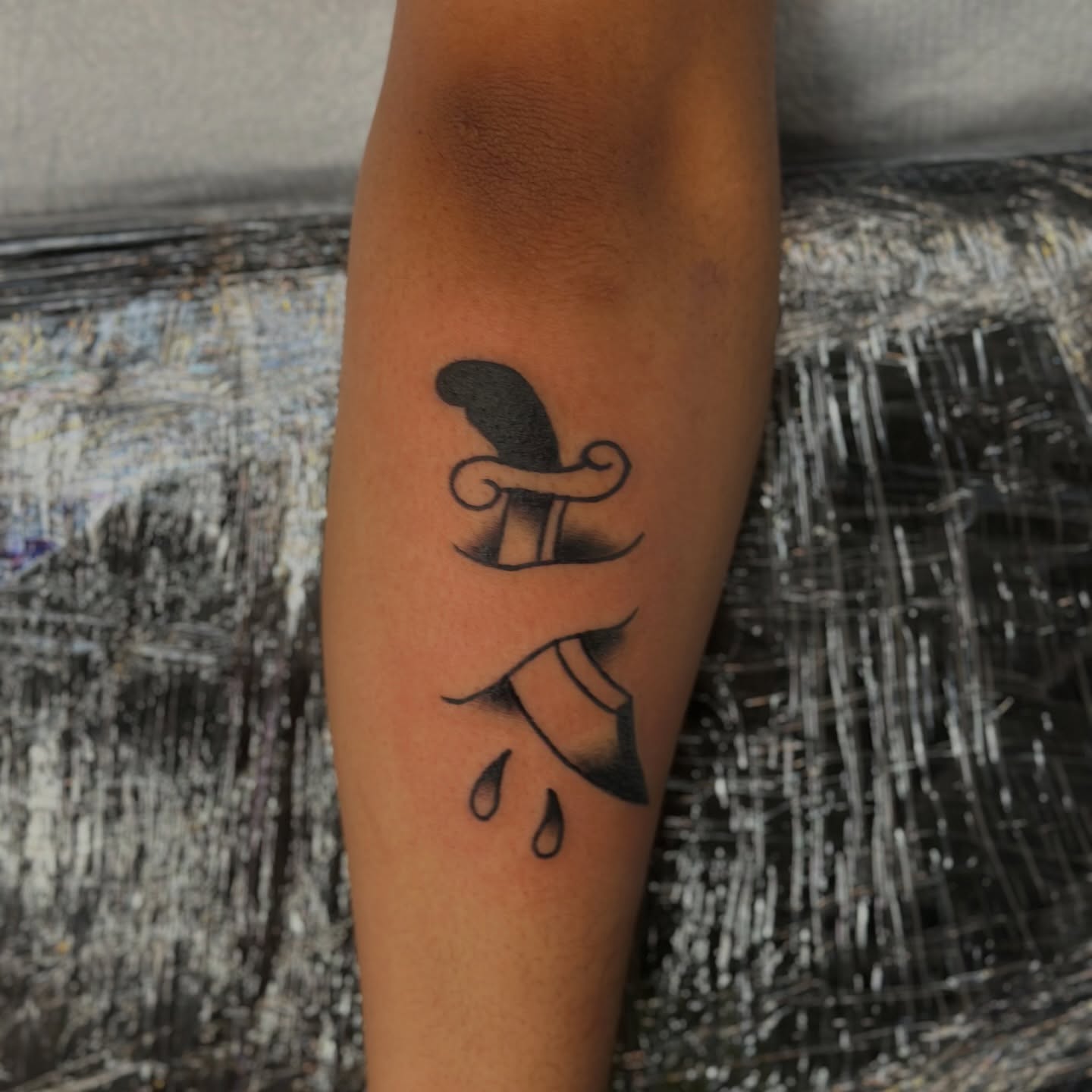 Hat and ribbon black and grey tattoo on the forearm by Tyyler Santor (Tattoo Artist), Somerville, Massachusetts