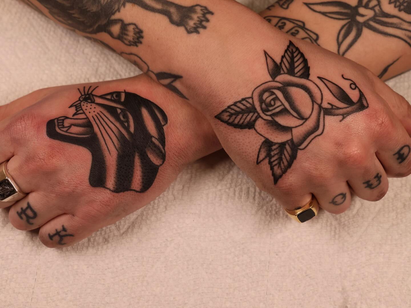 Cat and rose American traditional tattoo on the hand by Justin Rakowski