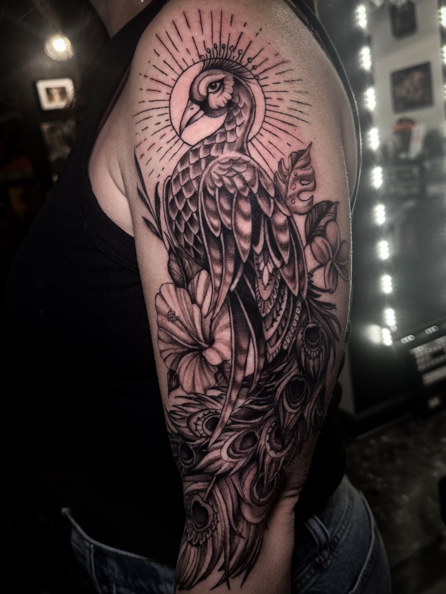 Peacock realism tattoo on the forearm by Cristen Aro